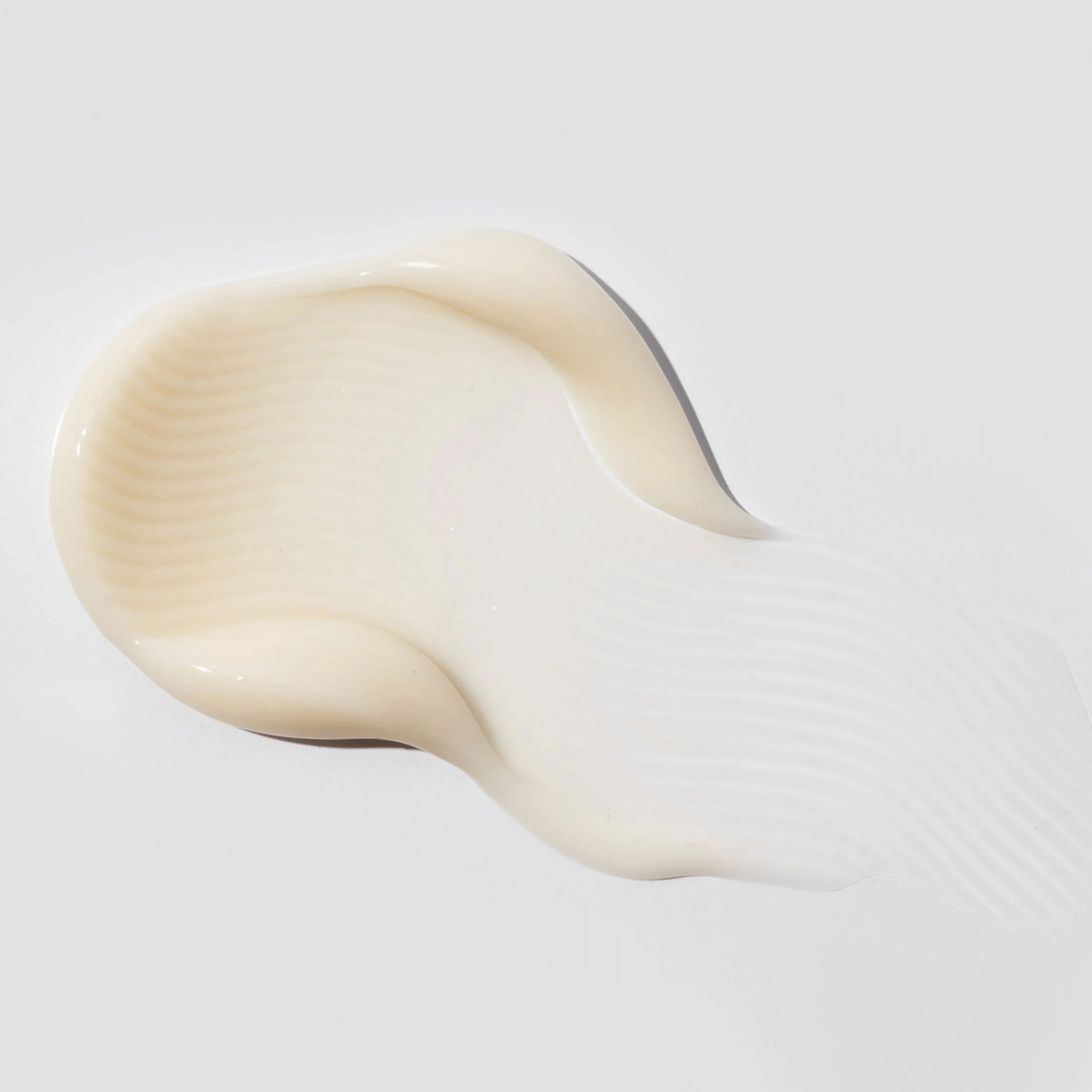 Close-up of a beige humidify moisturiser skincare swatch on a light grey background