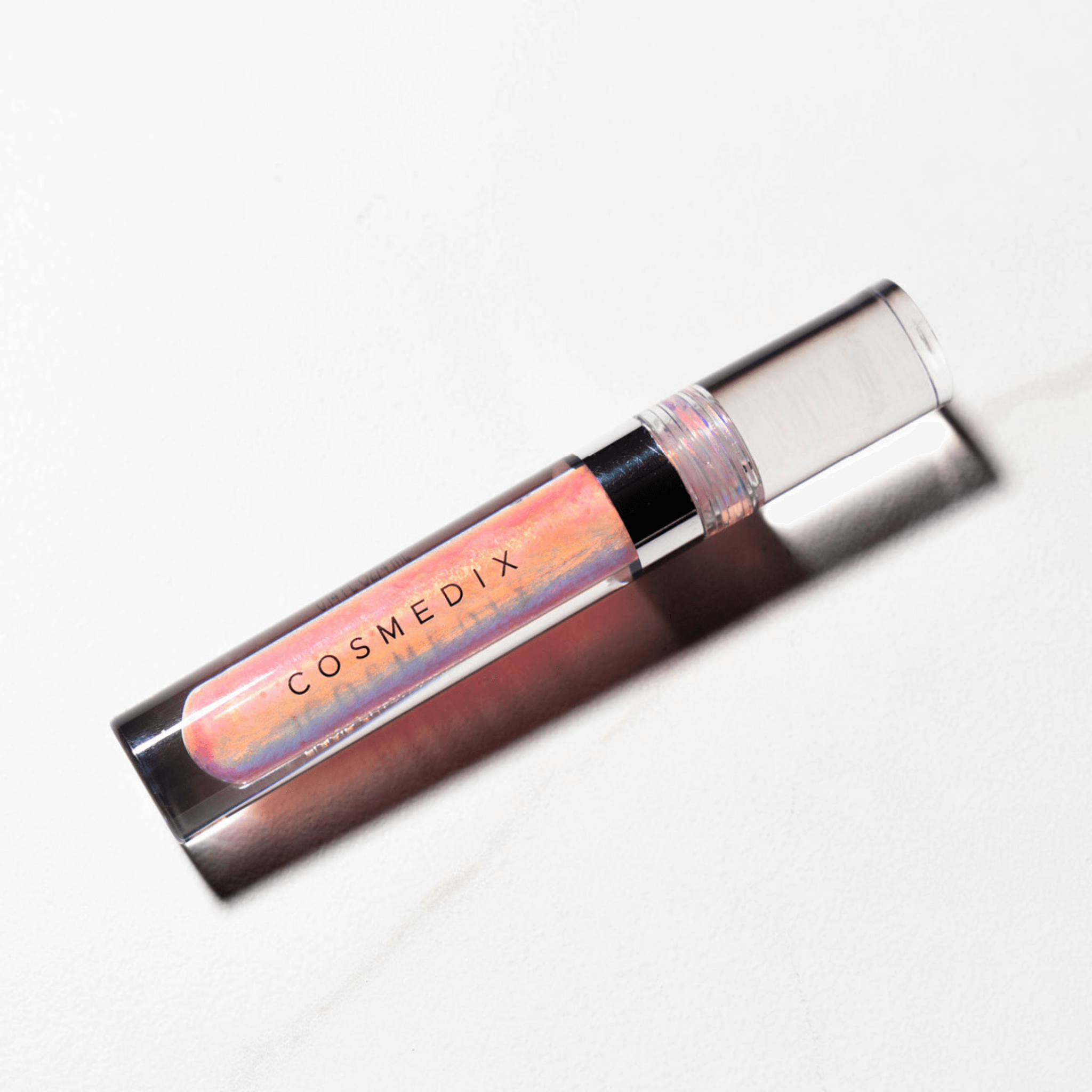 Cosmedix lip gloss on a white background
