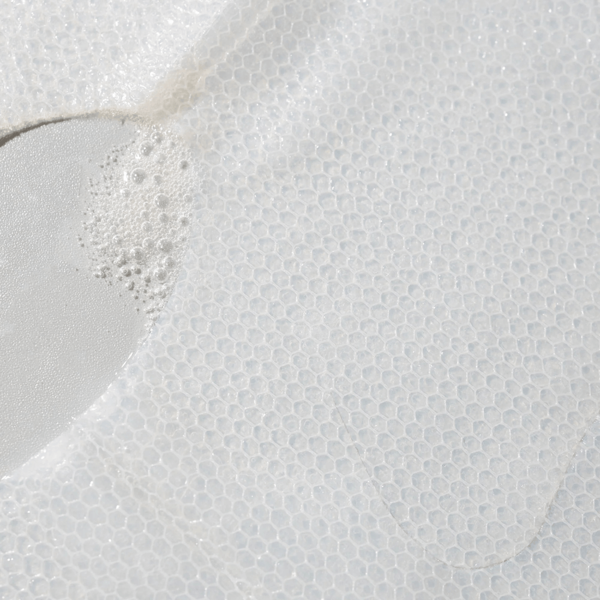 Close-up of a textured sheet mask soaked in Cosmedix Microbiome Micro Defence