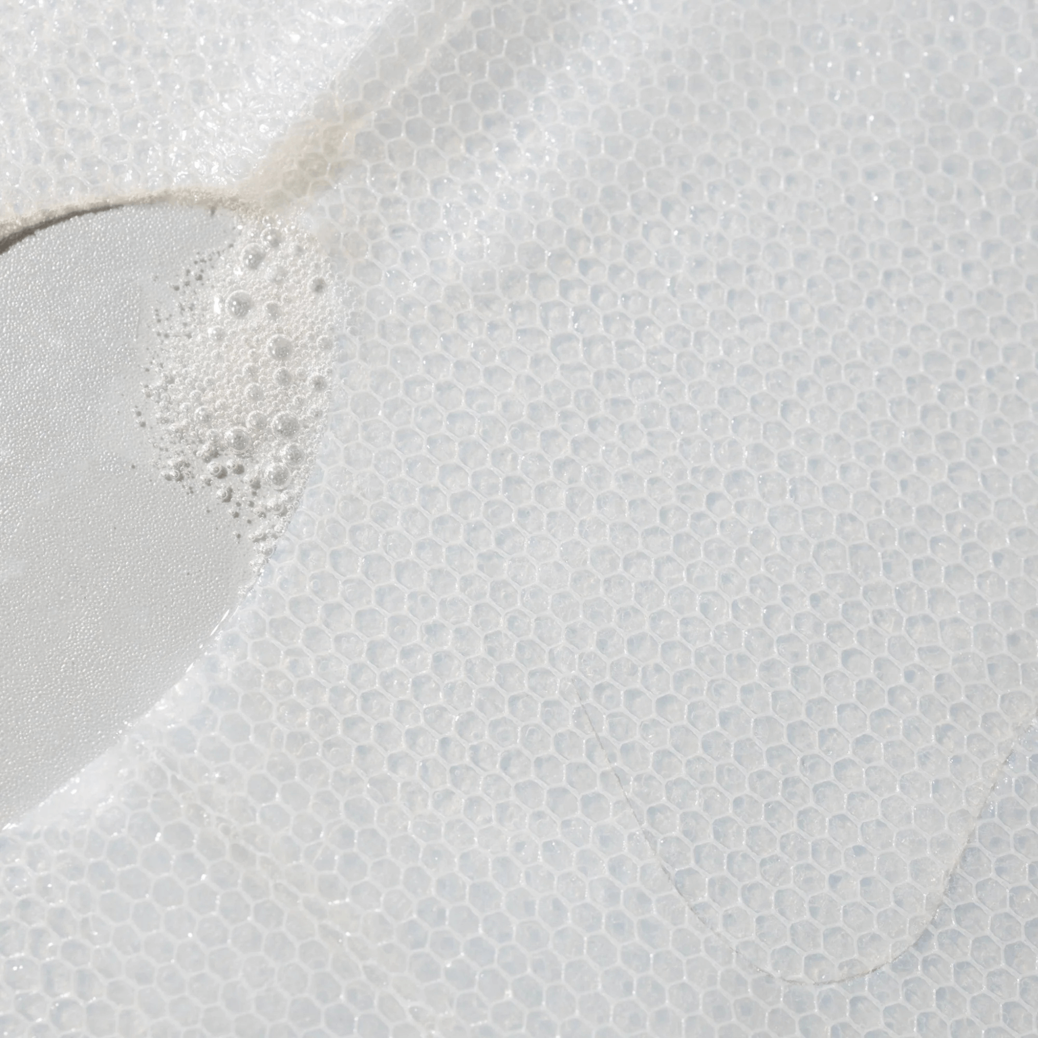 Close-up of a textured sheet mask soaked in Cosmedix Microbiome Micro Defence