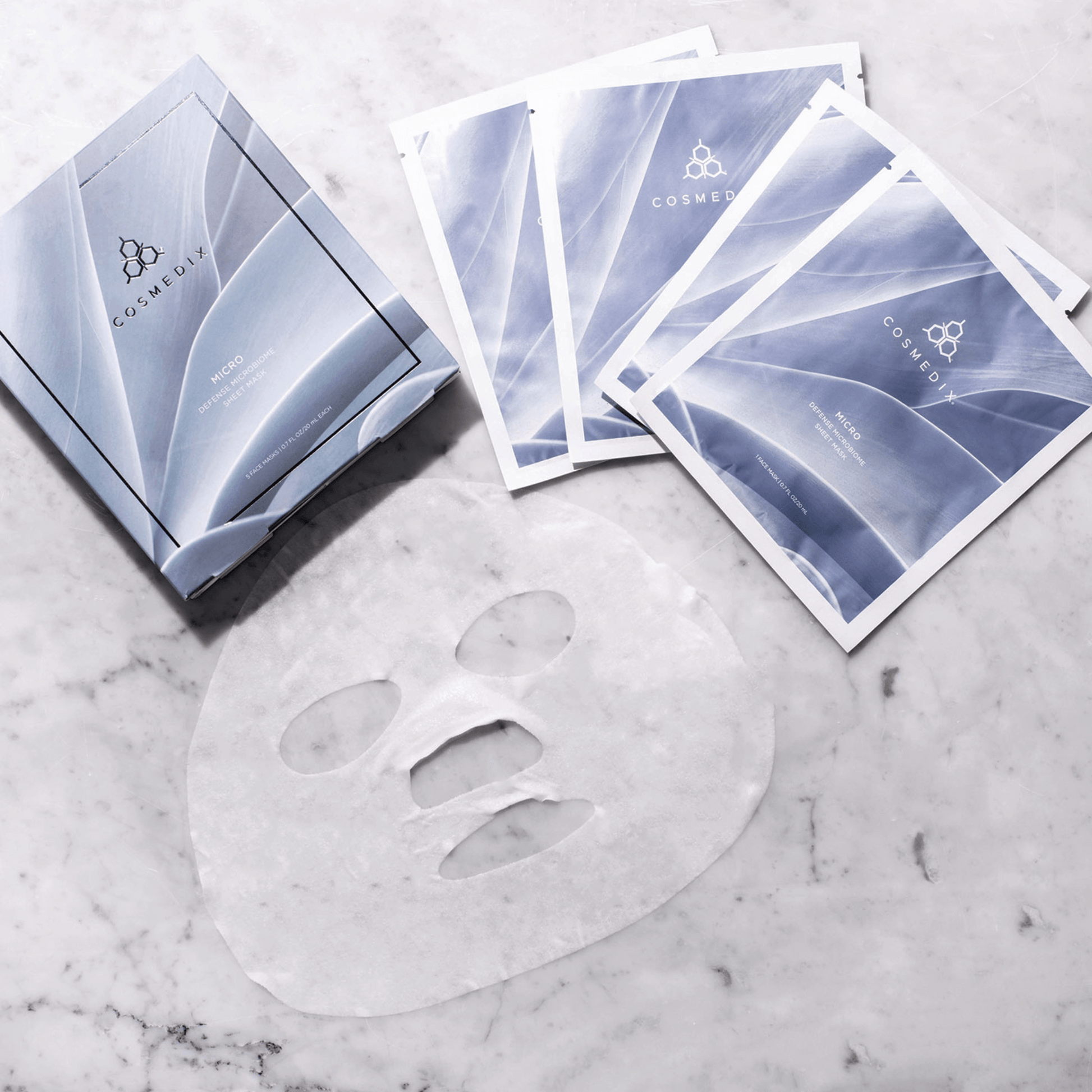 Cosmedix face mask sheet on a marble surface with packaging