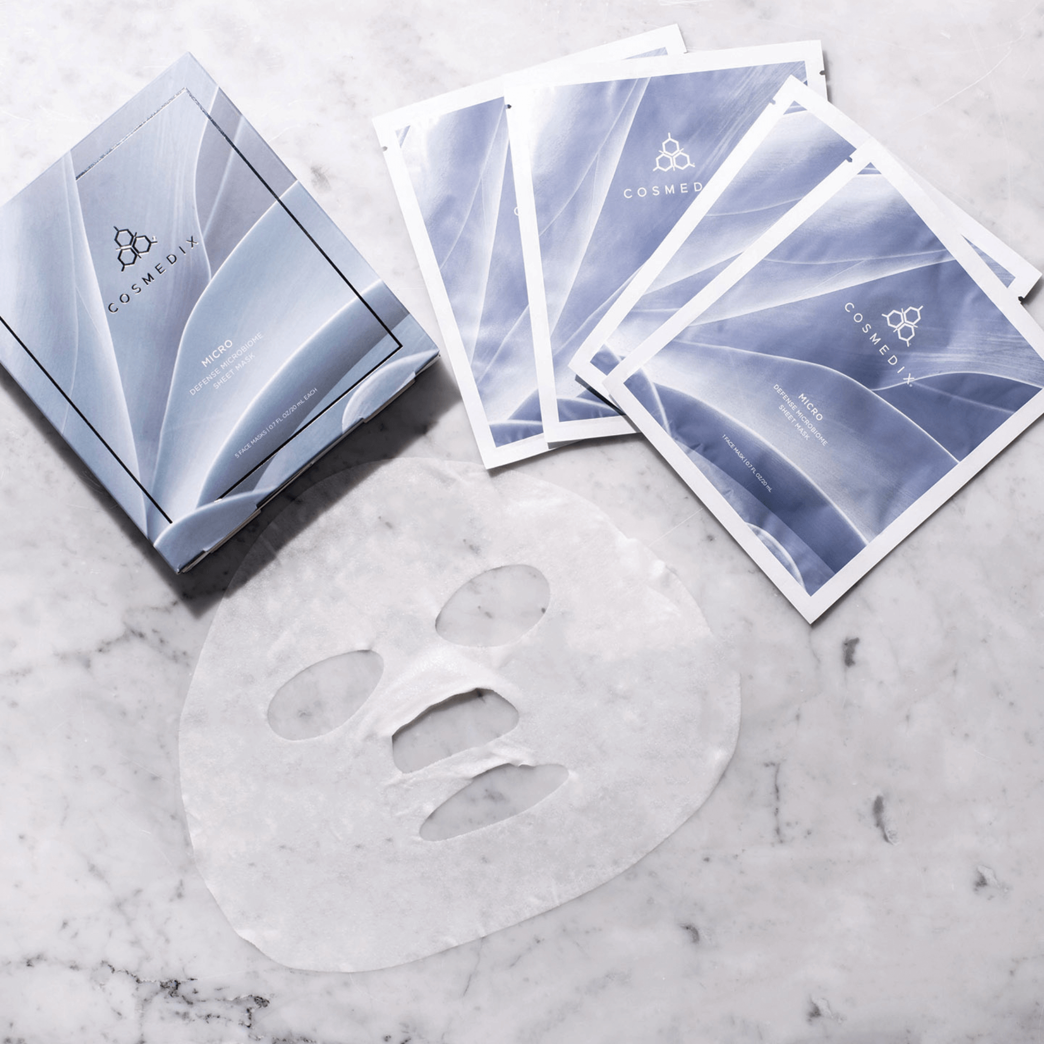 Cosmedix face mask sheet on a marble surface with packaging