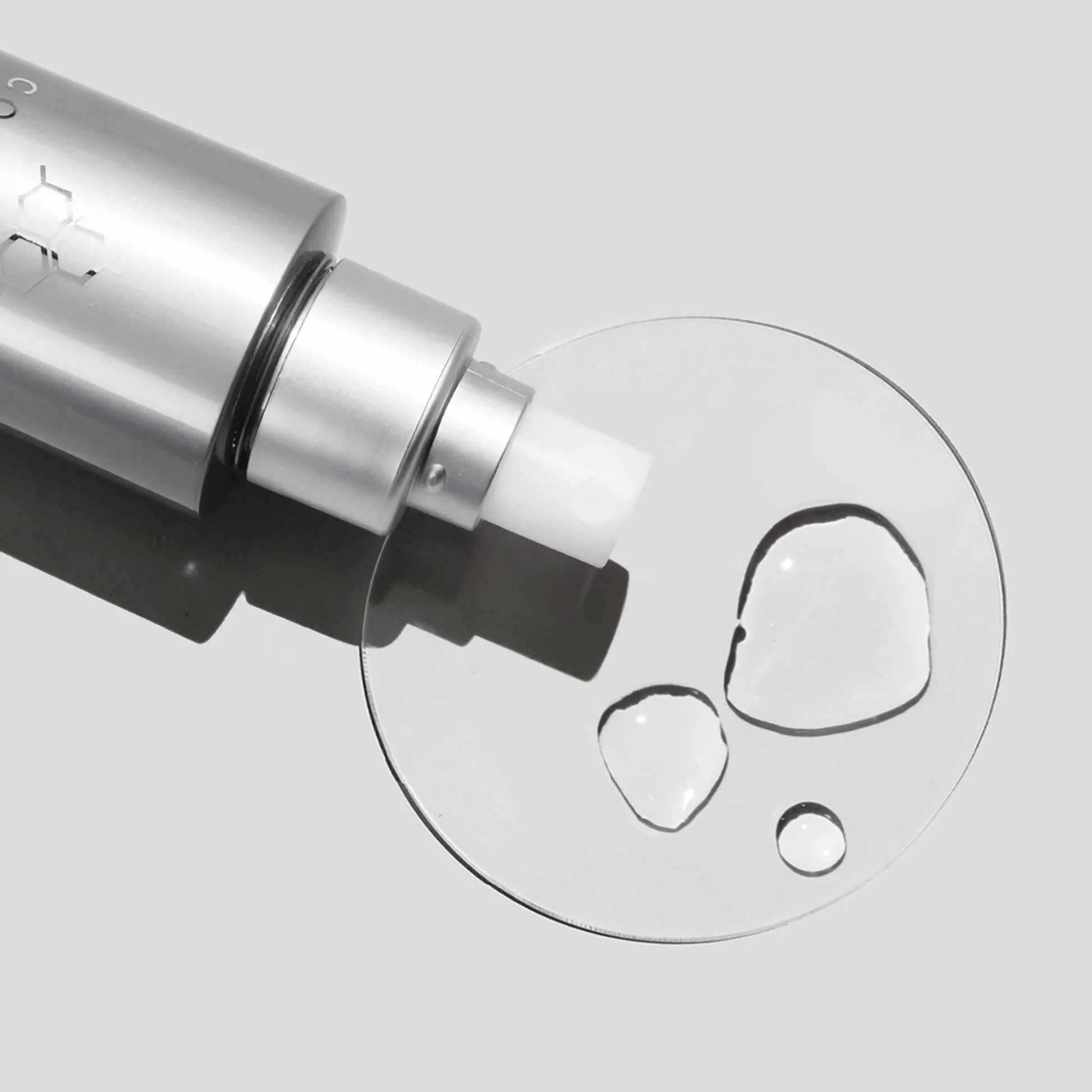 Close-up of Cosmedix Purity balance clear liquid droplet on a light grey background