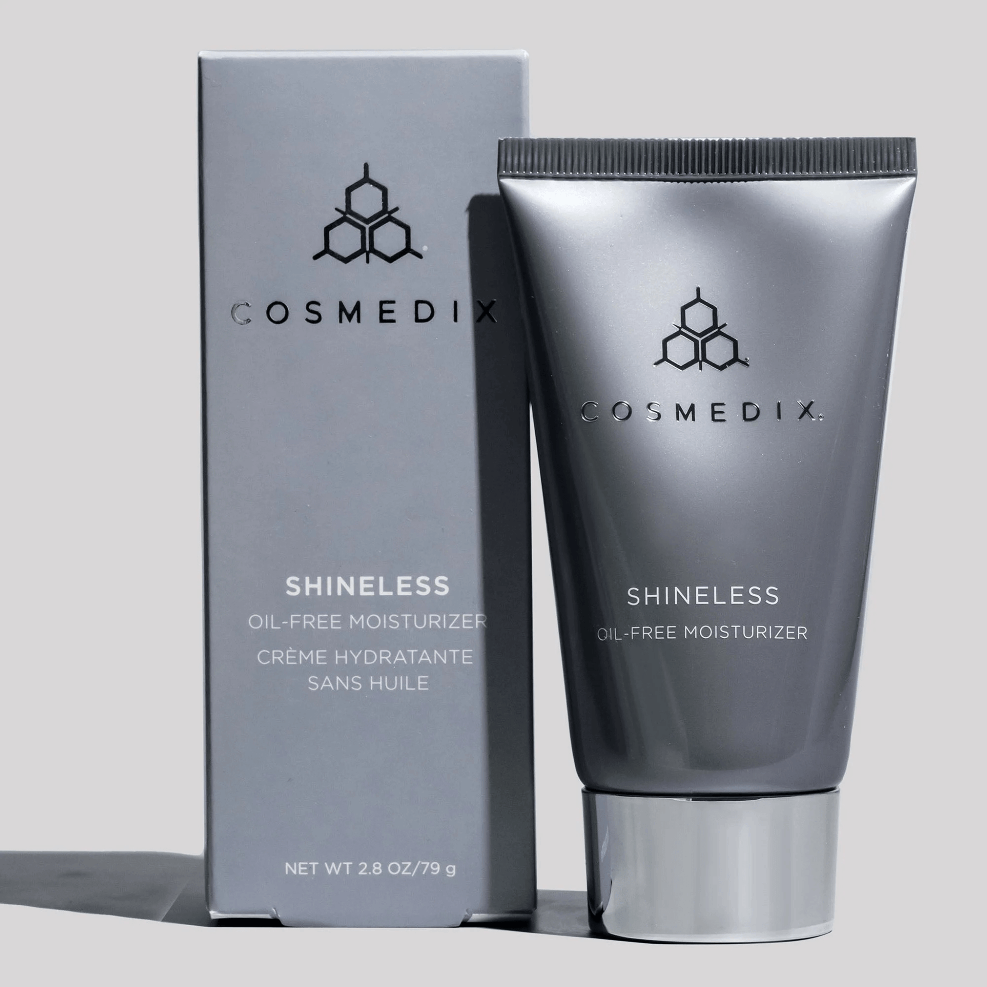 Cosmedix Shineless oil-free moisturiser tube and packaging on a light grey background