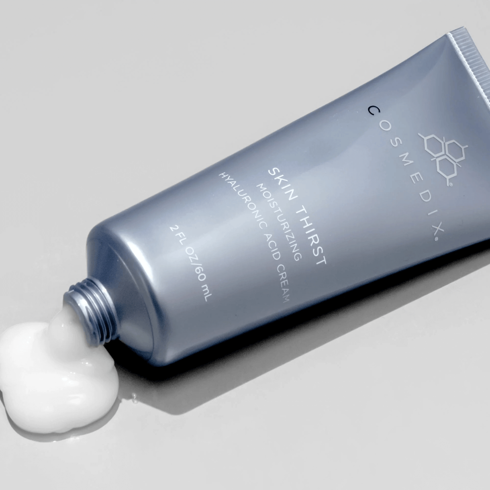 Cosmedix Skin Thirst moisturising cream tube with a small amount of cream on a grey background