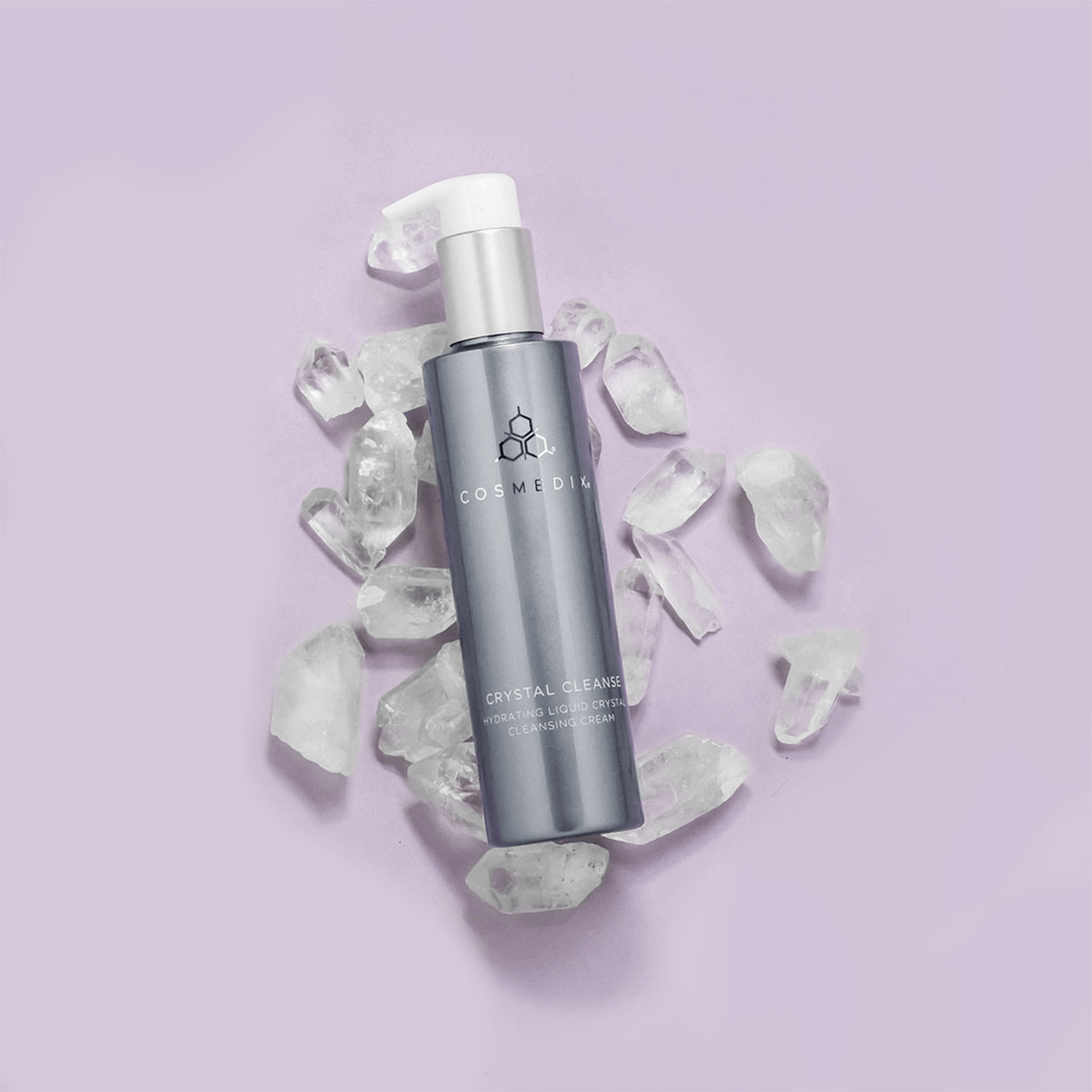 Cosmedix Crystal Cleanse surrounded by white crystals on a light purple background