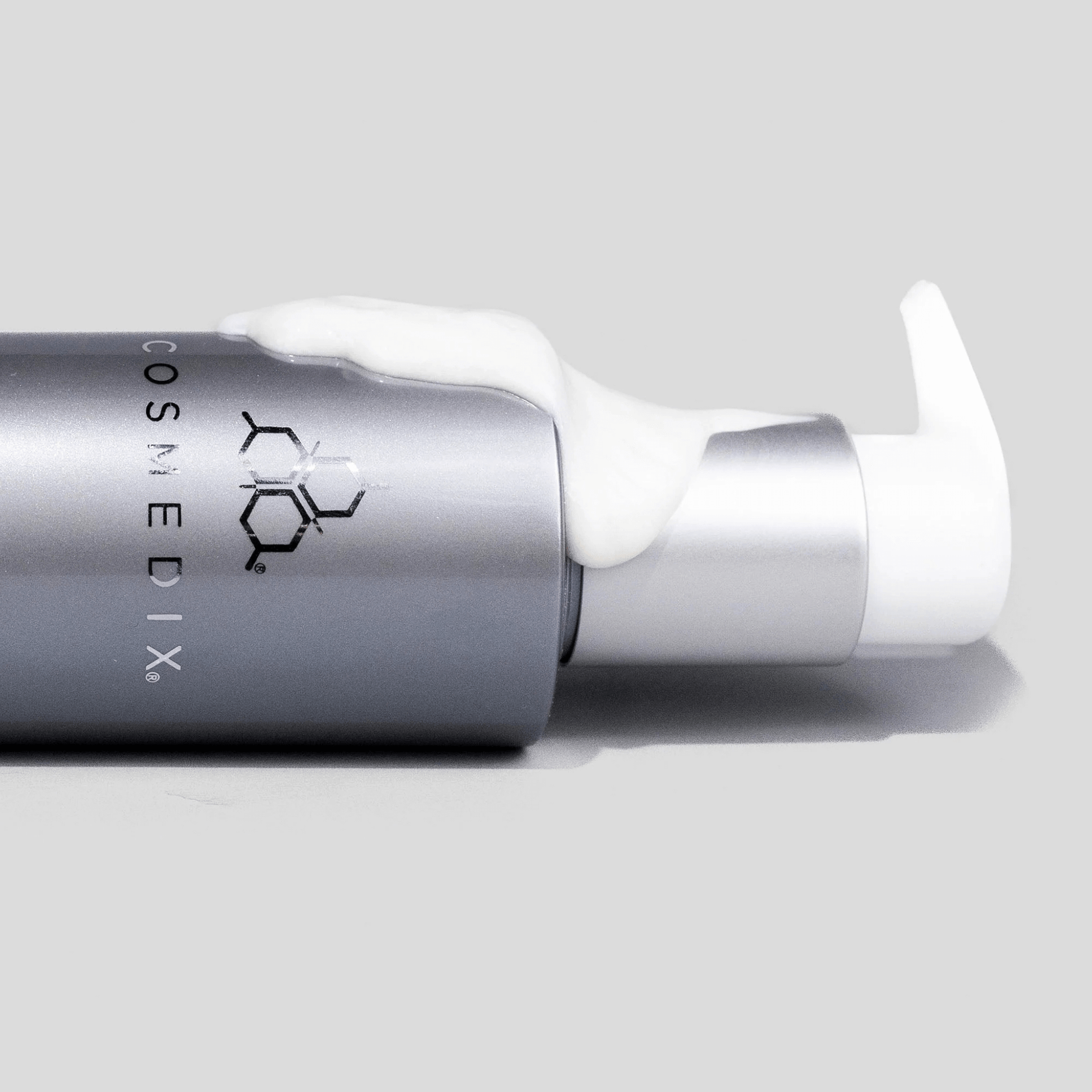 Cosmedix Crystal Cleanser with pump on a grey background