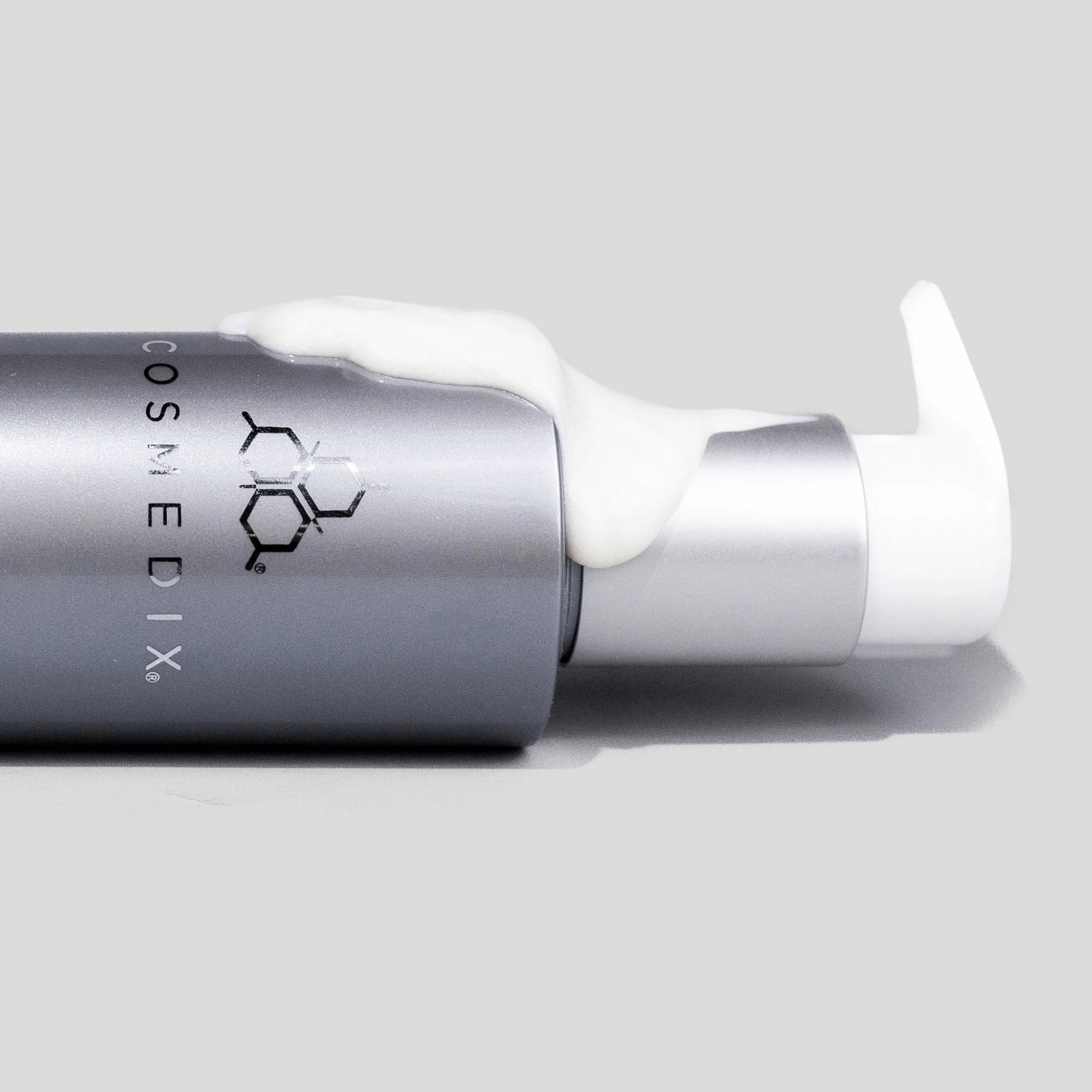 Cosmedix Crystal Cleanser with pump on a grey background