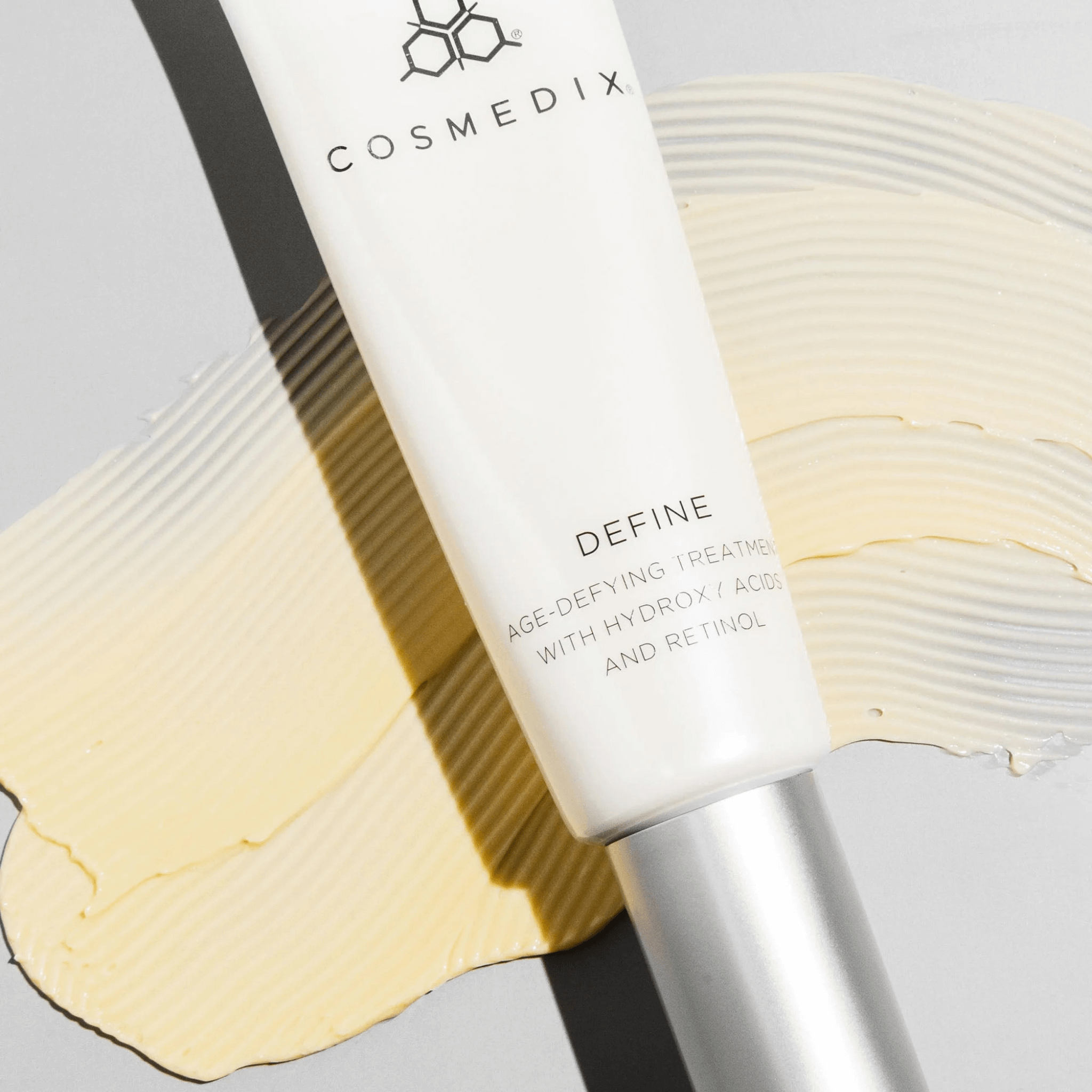 Cosmedix Define skincare treatment bottle on a swatch of define product