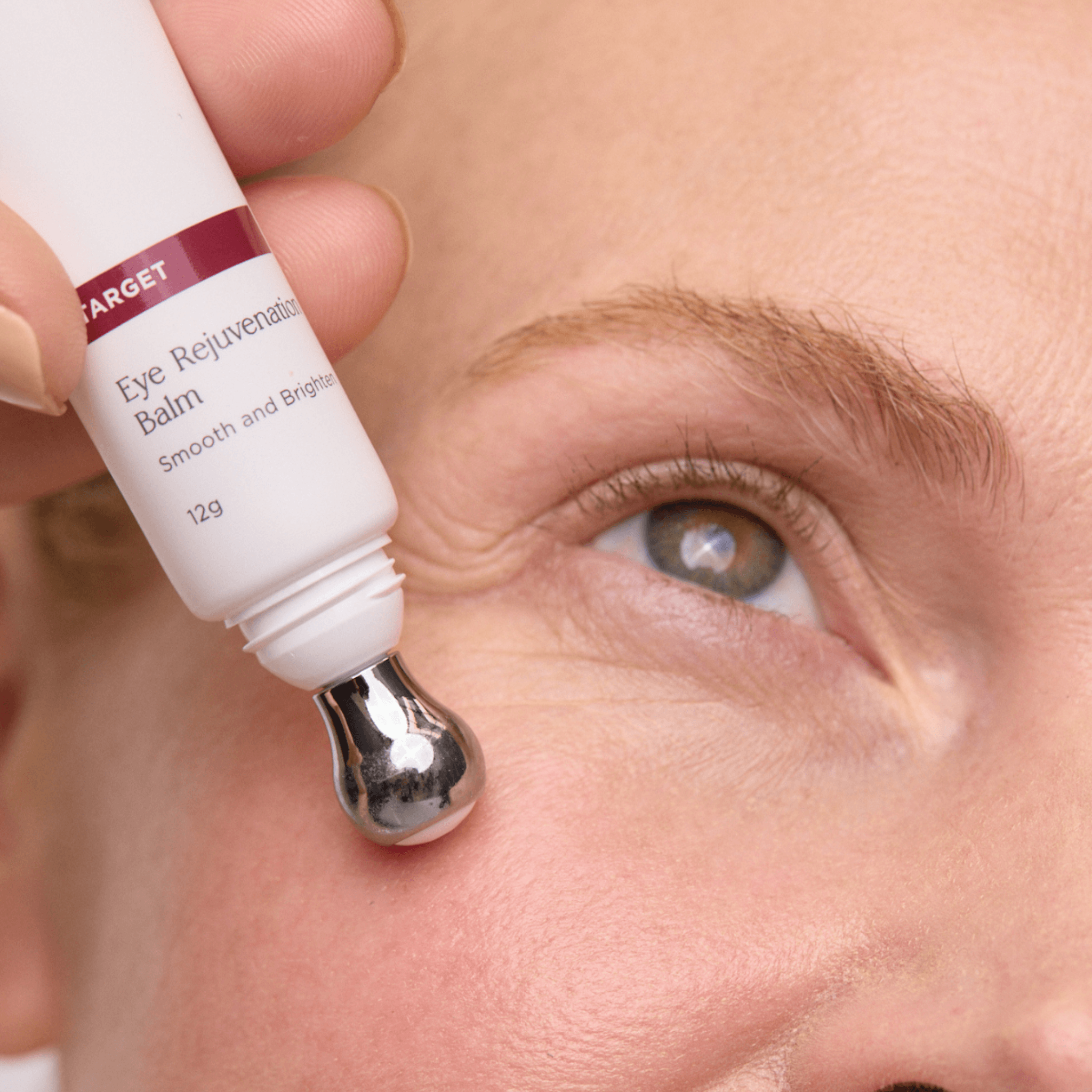 Close-up of a person applying Aspect Dr Eye Rejuvenation Balm to their eye area