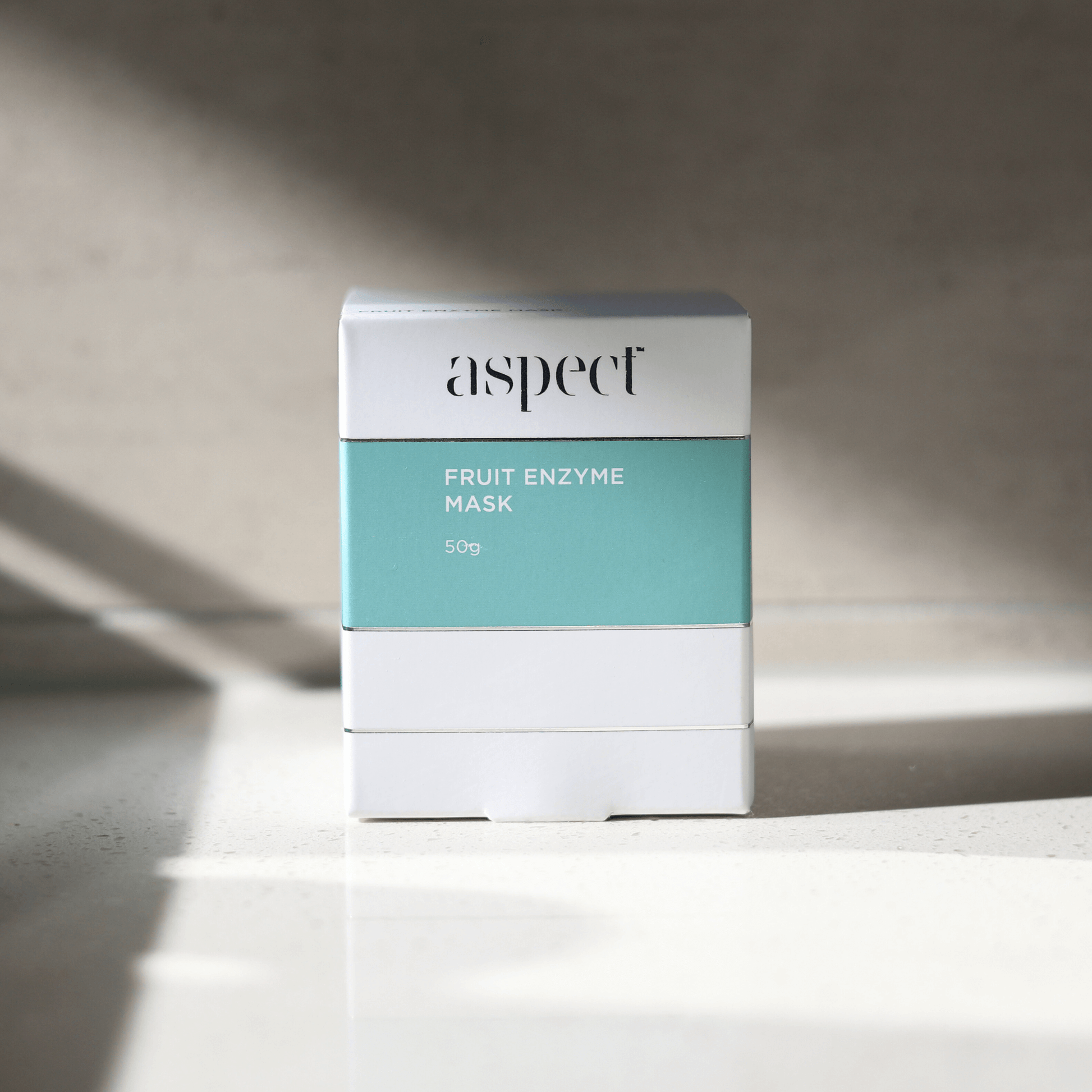 Aspect fruit enzyme mask packaging on a neutral background