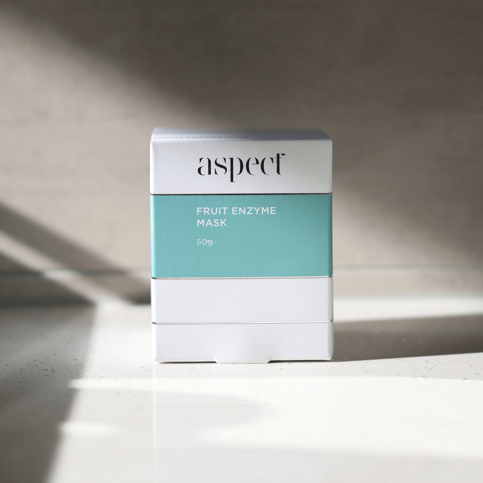 Aspect fruit enzyme mask packaging on a neutral background