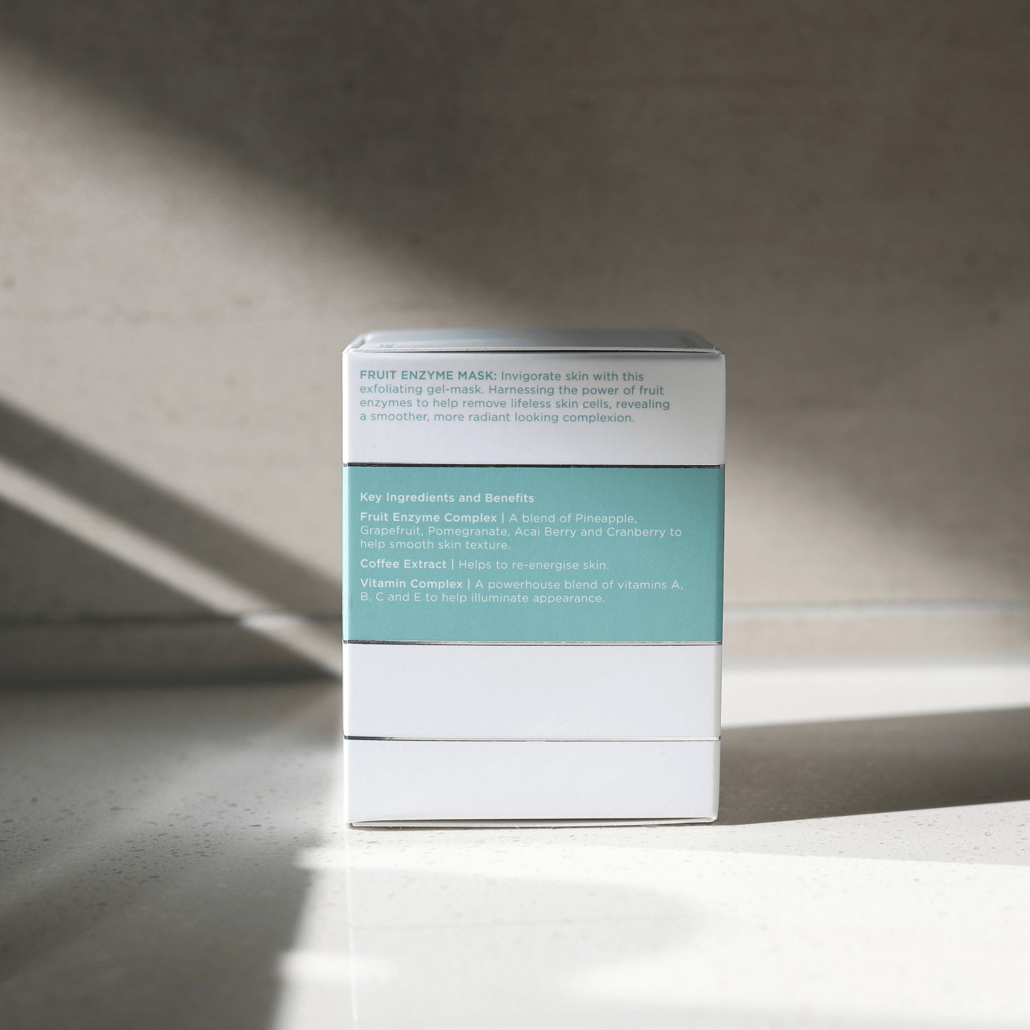 Aspect fruit enzyme mask side of box product packaging on a neutral background