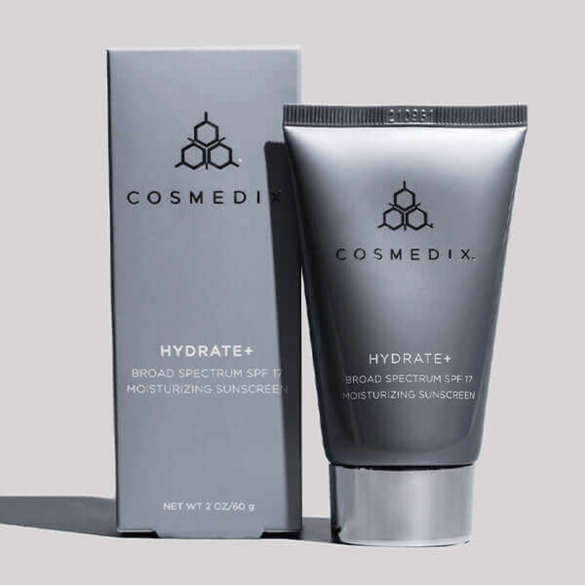 Cosmedix Hydrate+ moisturising sunscreen tube and packaging on a light grey background