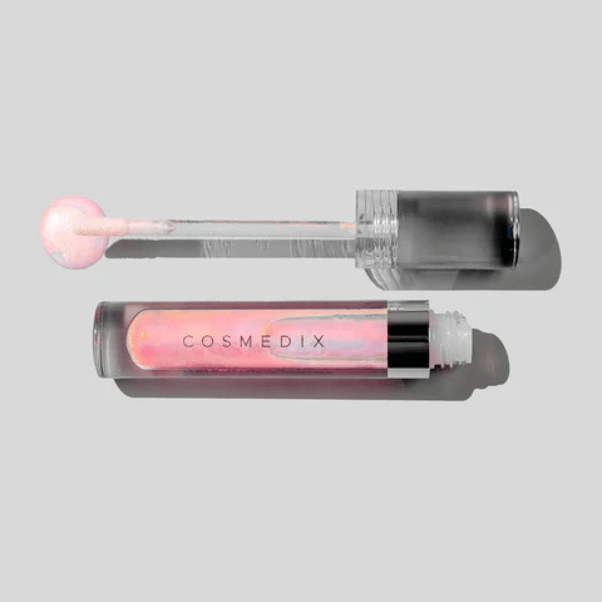 Cosmedix lip gloss Lumicrystal with applicator on a light grey background