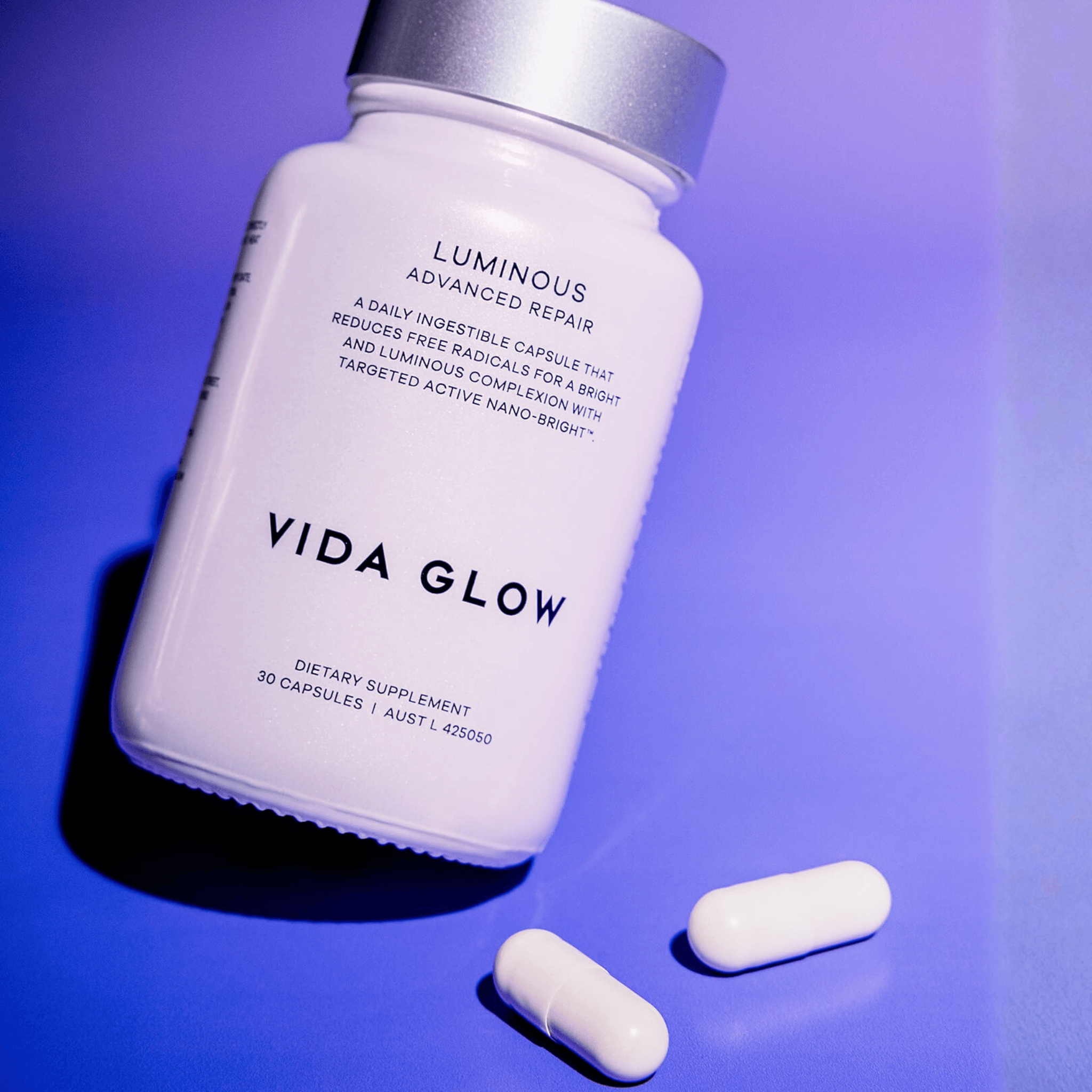 Luminous Radiance Plus Capsules and packaging Vida Glow on purple background