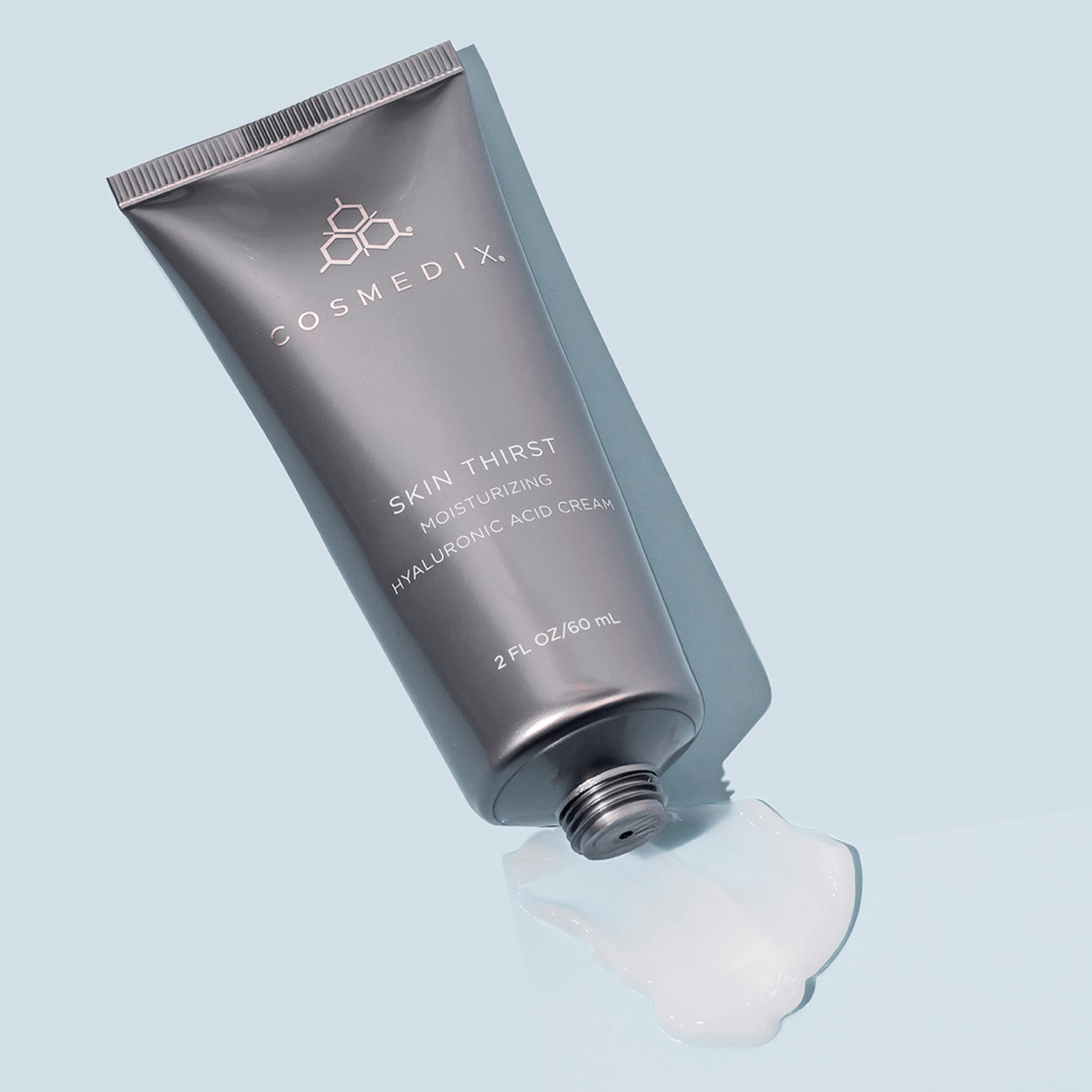 Cosmedix Skin Thirst cream tube on a light blue background