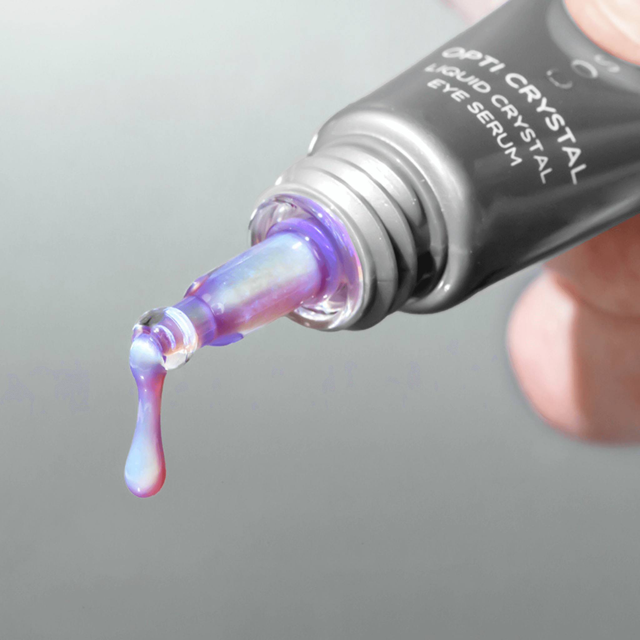 Opti Crystal Liquid Crystal Eye Serum dripping from dropper on a grey background
