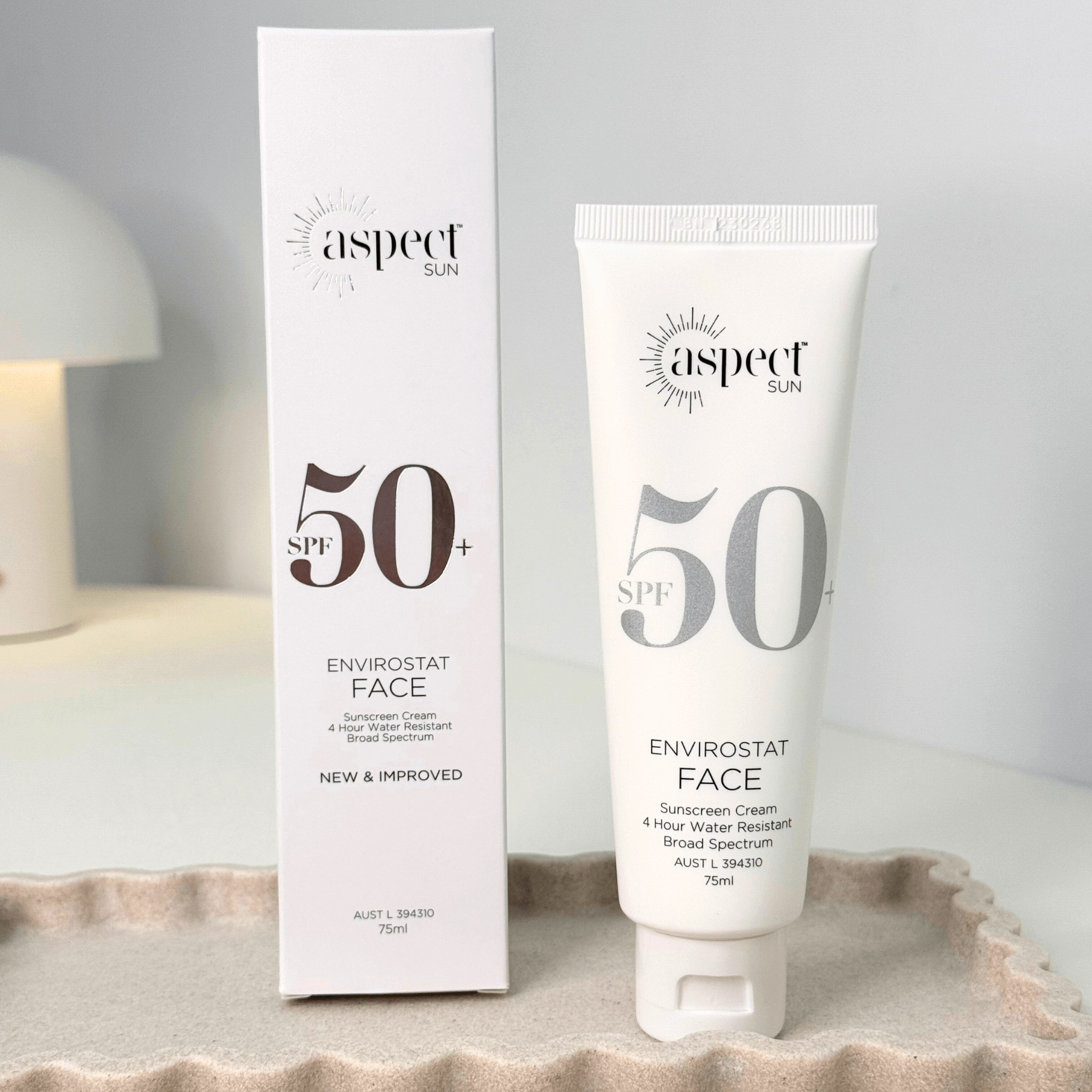 Aspect Sun SPF 50+ Envirostat Face sunscreen cream and packaging on a neutral background