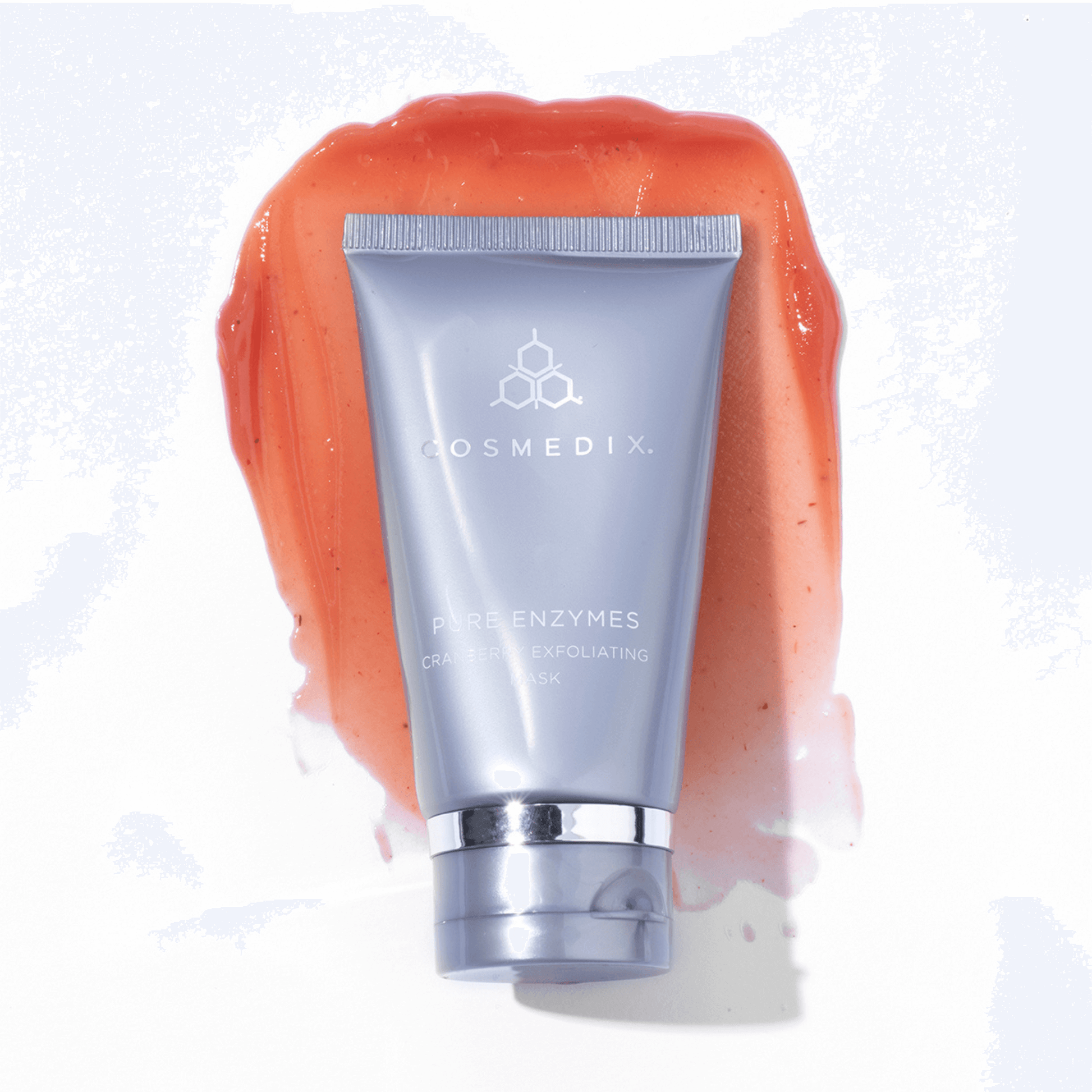 Cosmedix exfoliating scrub with orange enzyme scrub on a white background