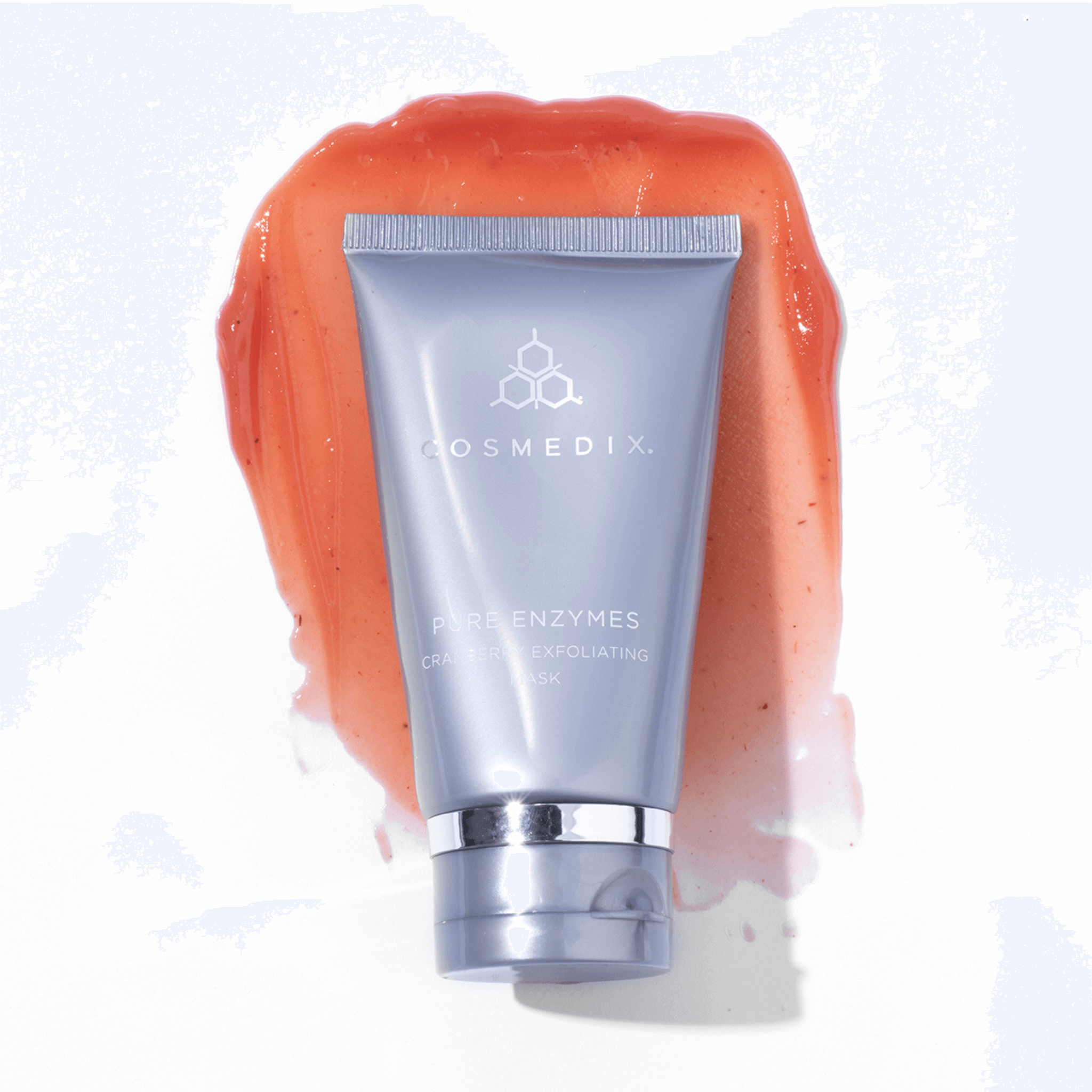 Cosmedix exfoliating scrub with orange enzyme scrub on a white background