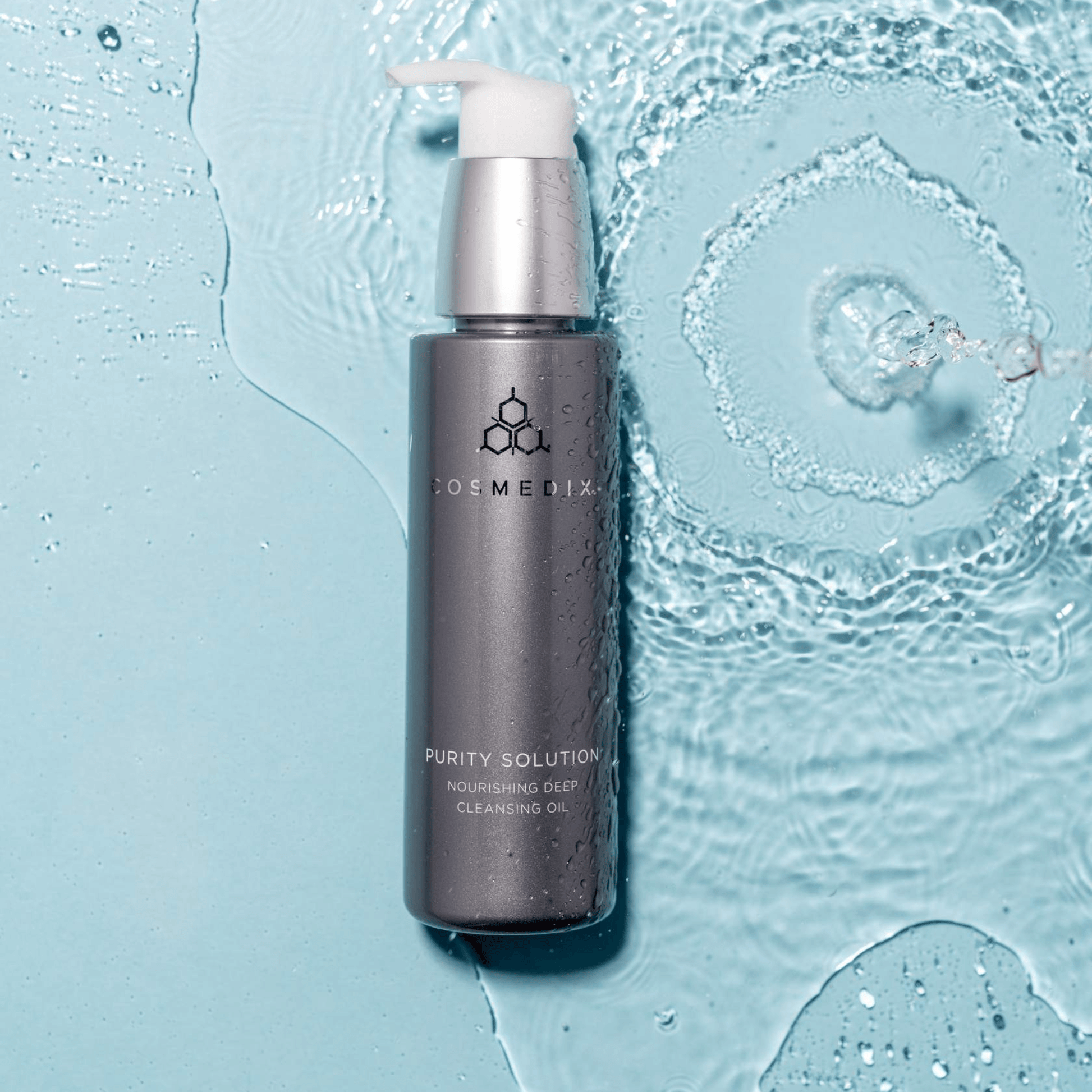 Cosmedix Purity Solution bottle on a blue textured background