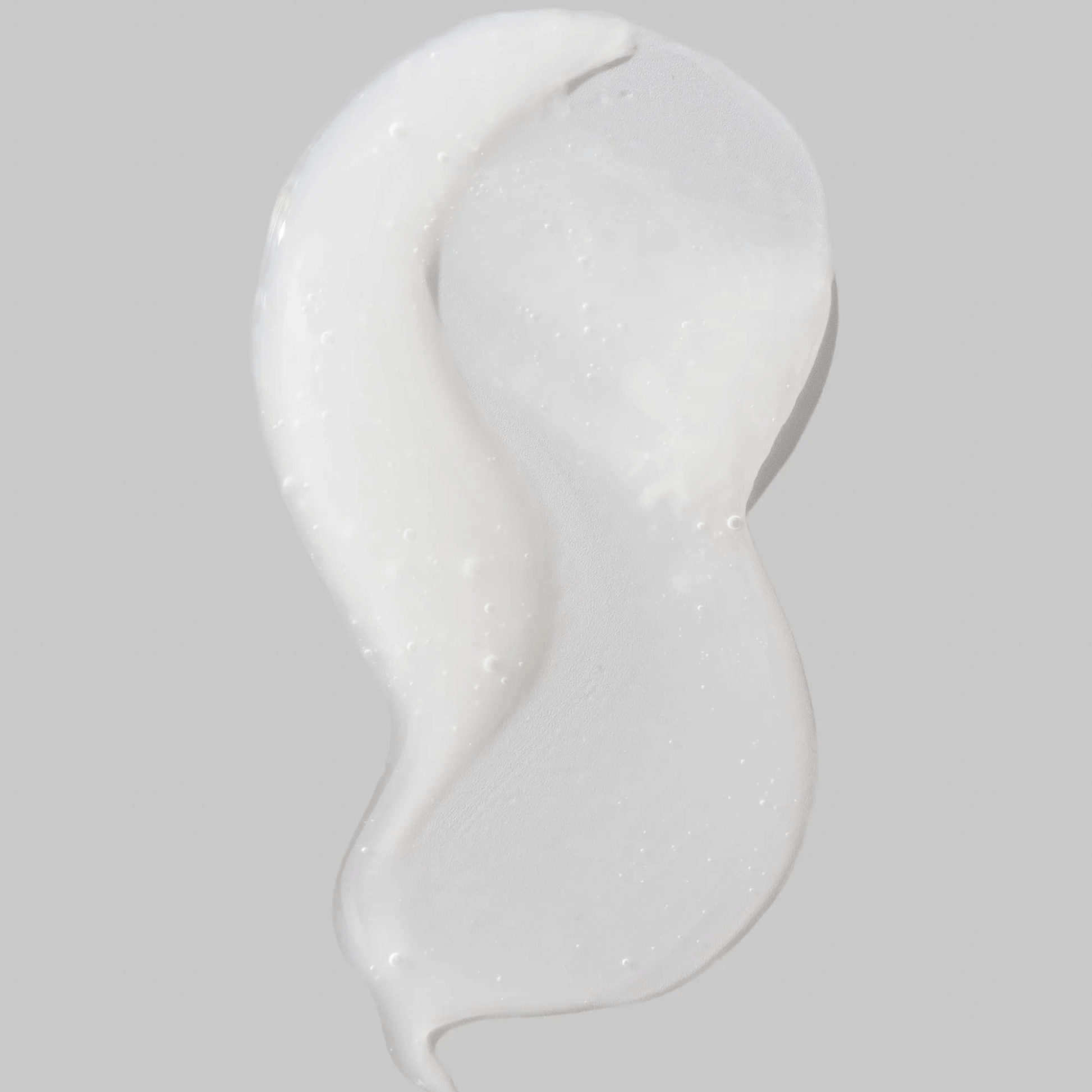 Cosmedix Reboot Complex white cream swatch on a grey background