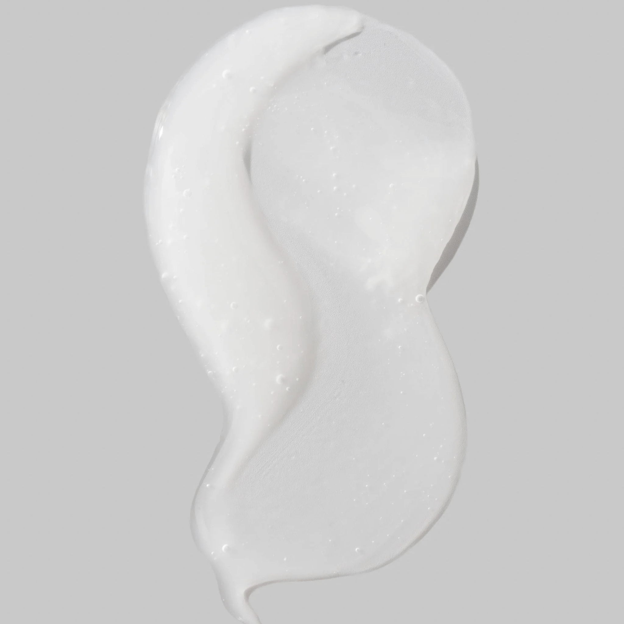 Cosmedix Reboot Complex white cream swatch on a grey background