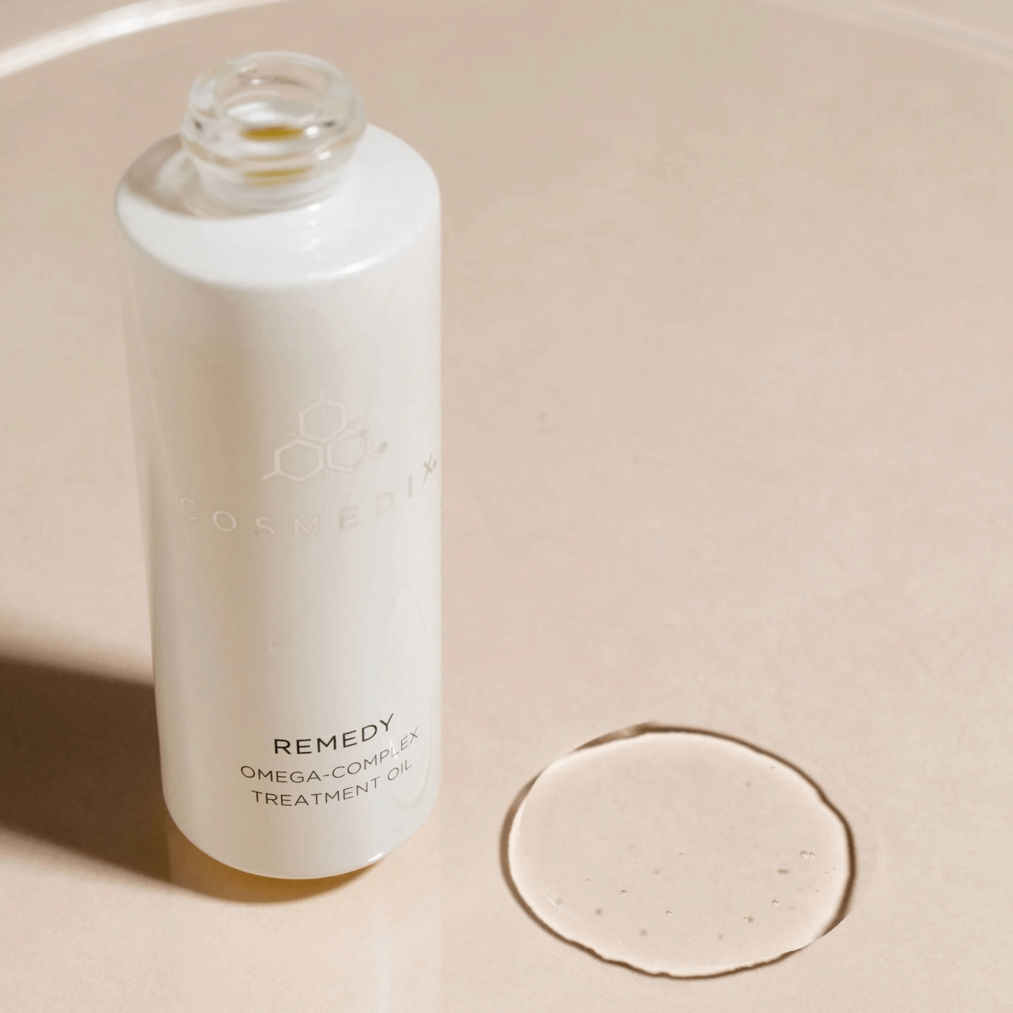 Cosmedix Remedy Omega-Complex treatment Oil on a beige background
