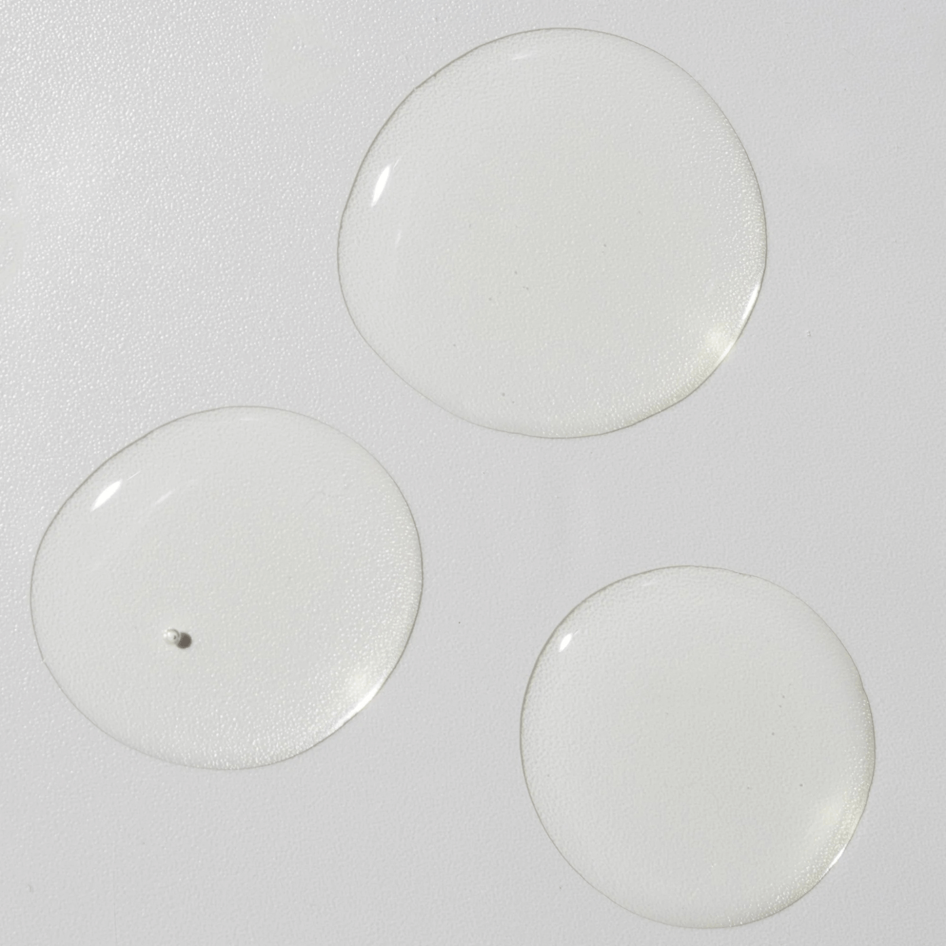 Three skincare drops of Cosmedix Remedy Oil on a white background