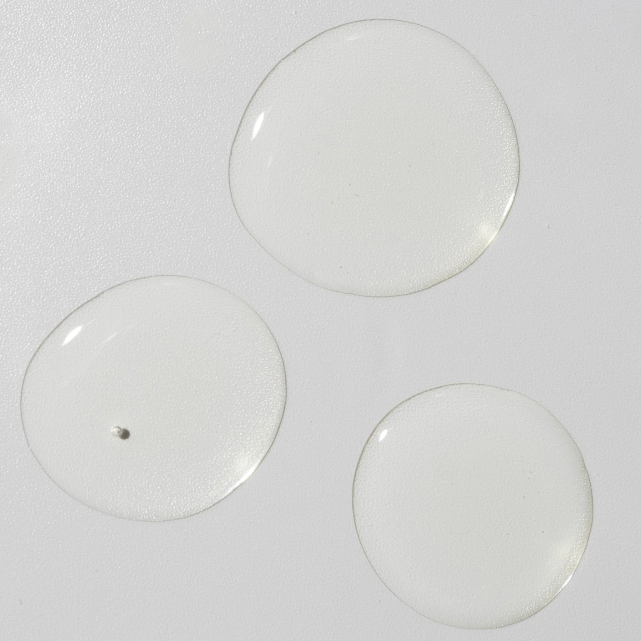 Three skincare drops of Cosmedix Remedy Oil on a white background