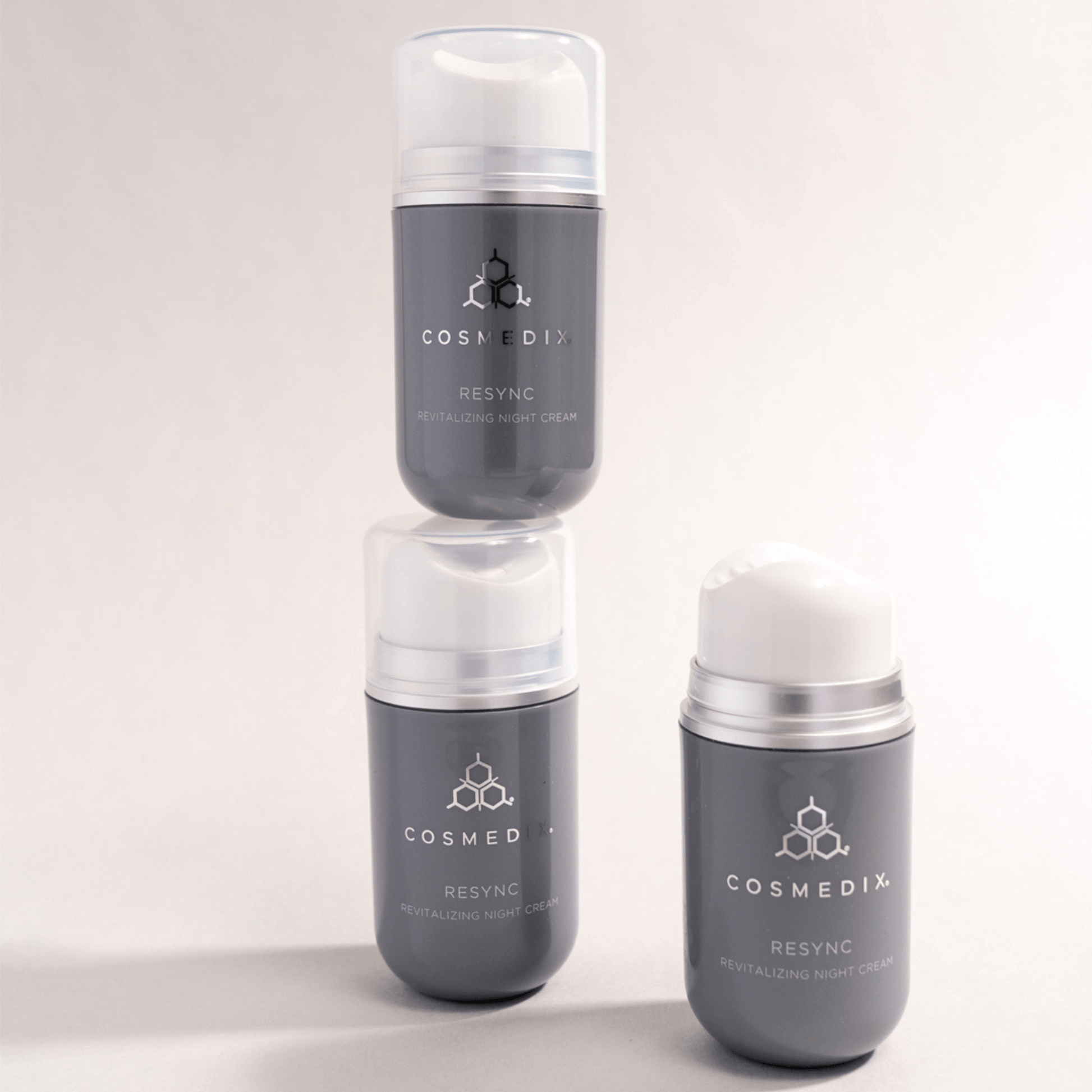 Three Cosmedix Resync night cream skincare products stacked on a light grey background