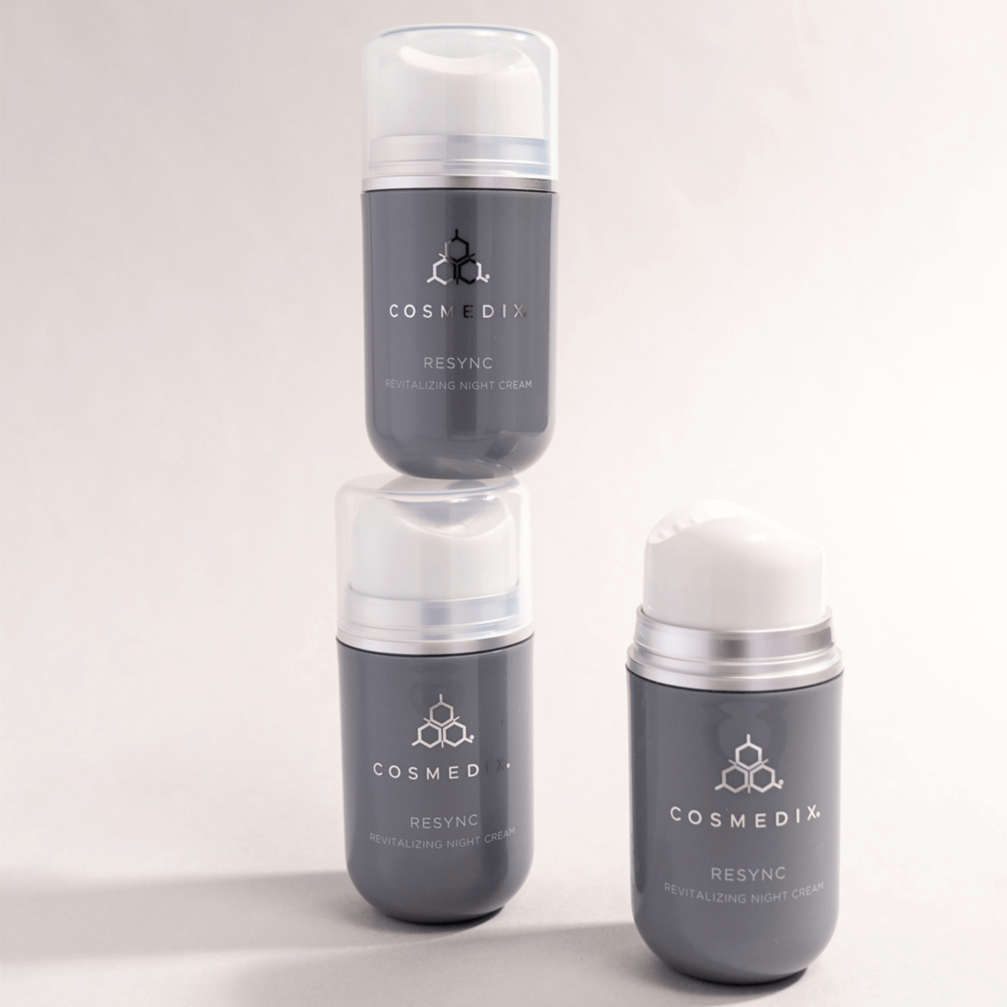 Three Cosmedix Resync night cream skincare products stacked on a light grey background