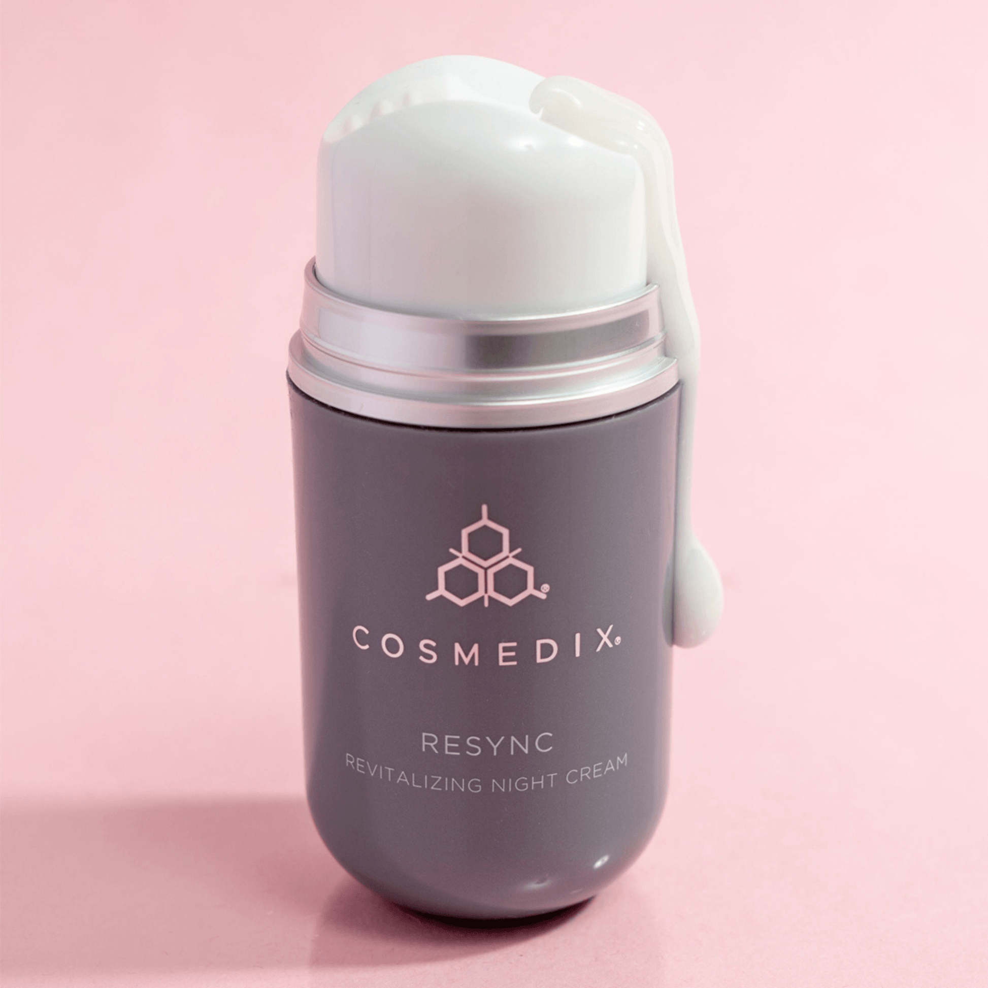 Cosmedix Resync revitalizing night cream on a pink background