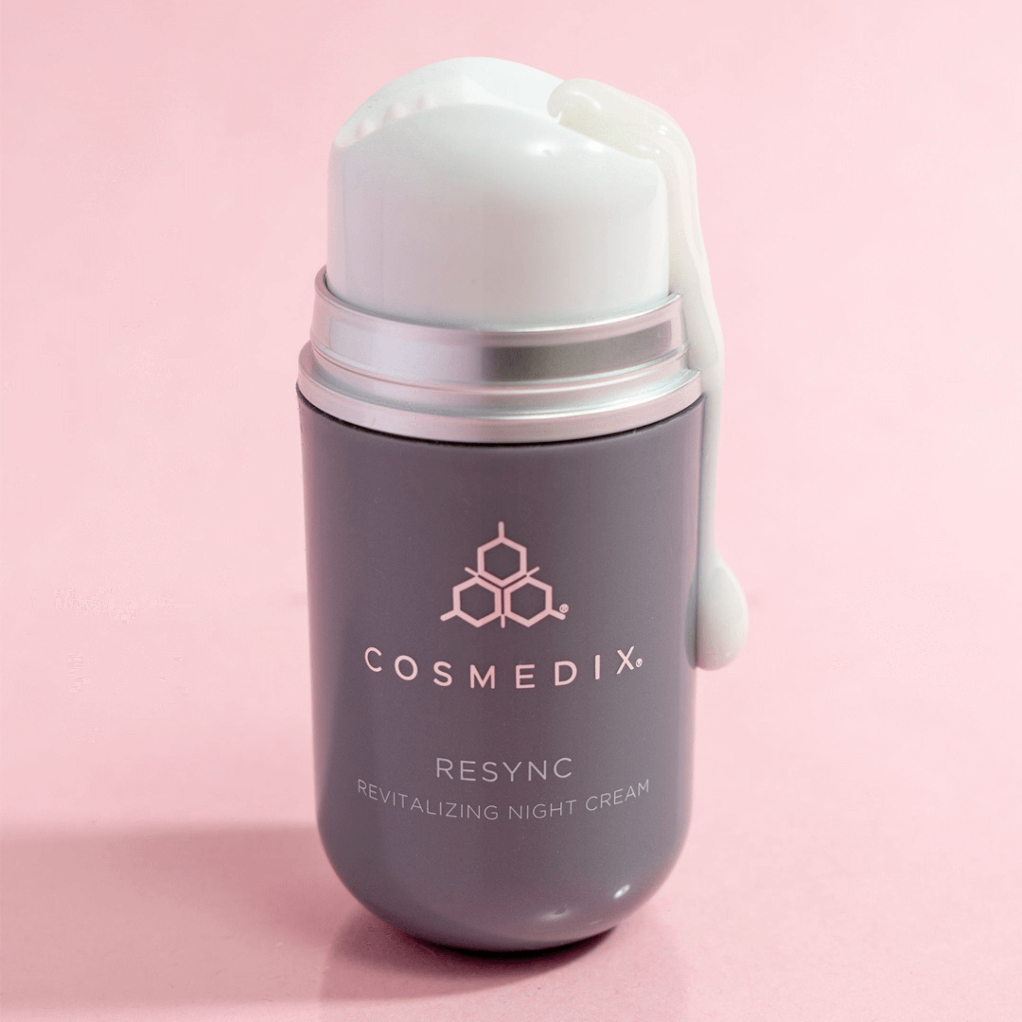 Cosmedix Resync revitalizing night cream on a pink background