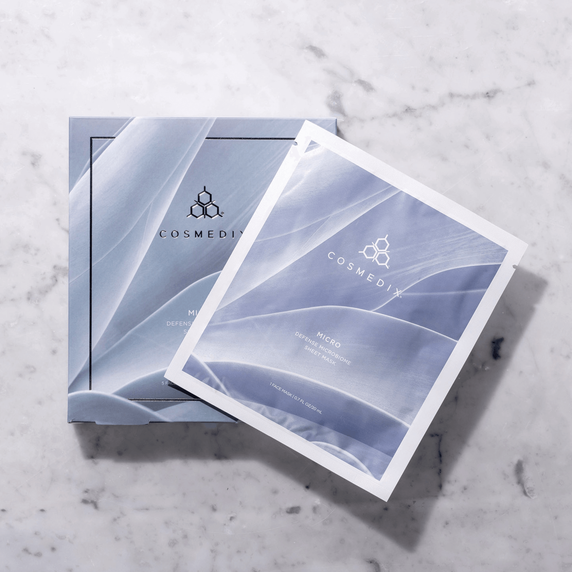 Cosmedix sheet masks on a marble surface