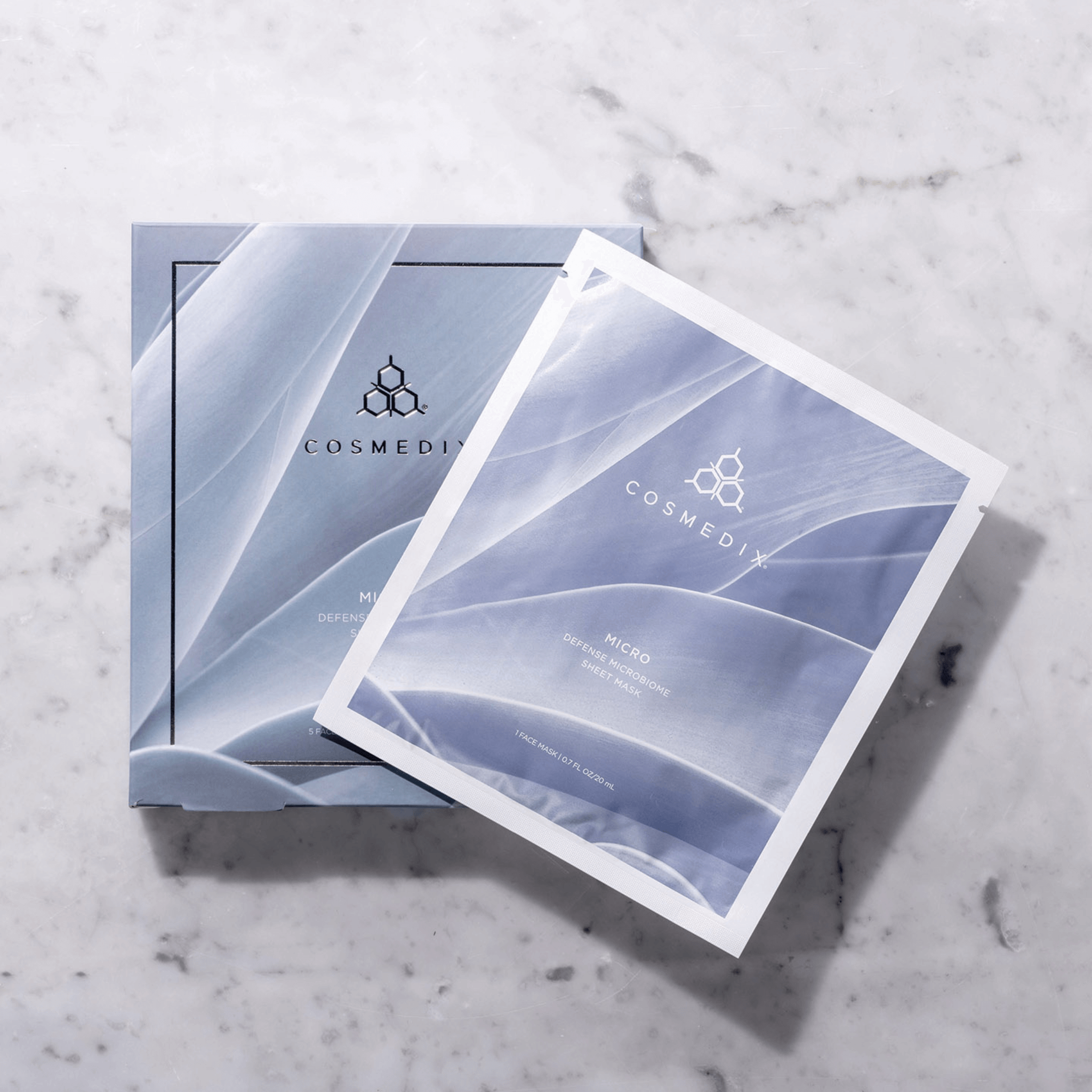 Cosmedix sheet masks on a marble surface