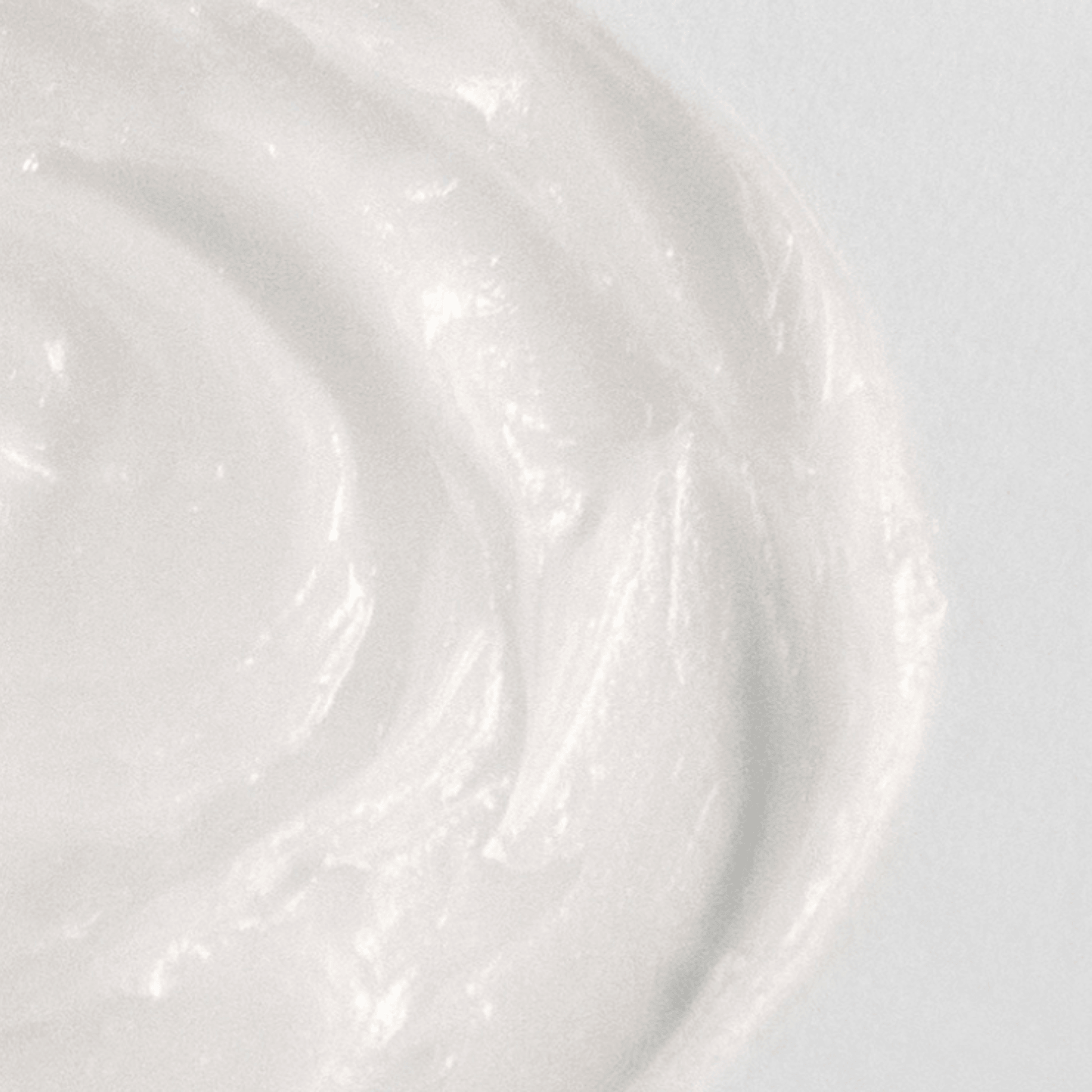 Aspect Dr Soothing Balm close-up texture shot of a thick, creamy white cream swirled on a light grey background.