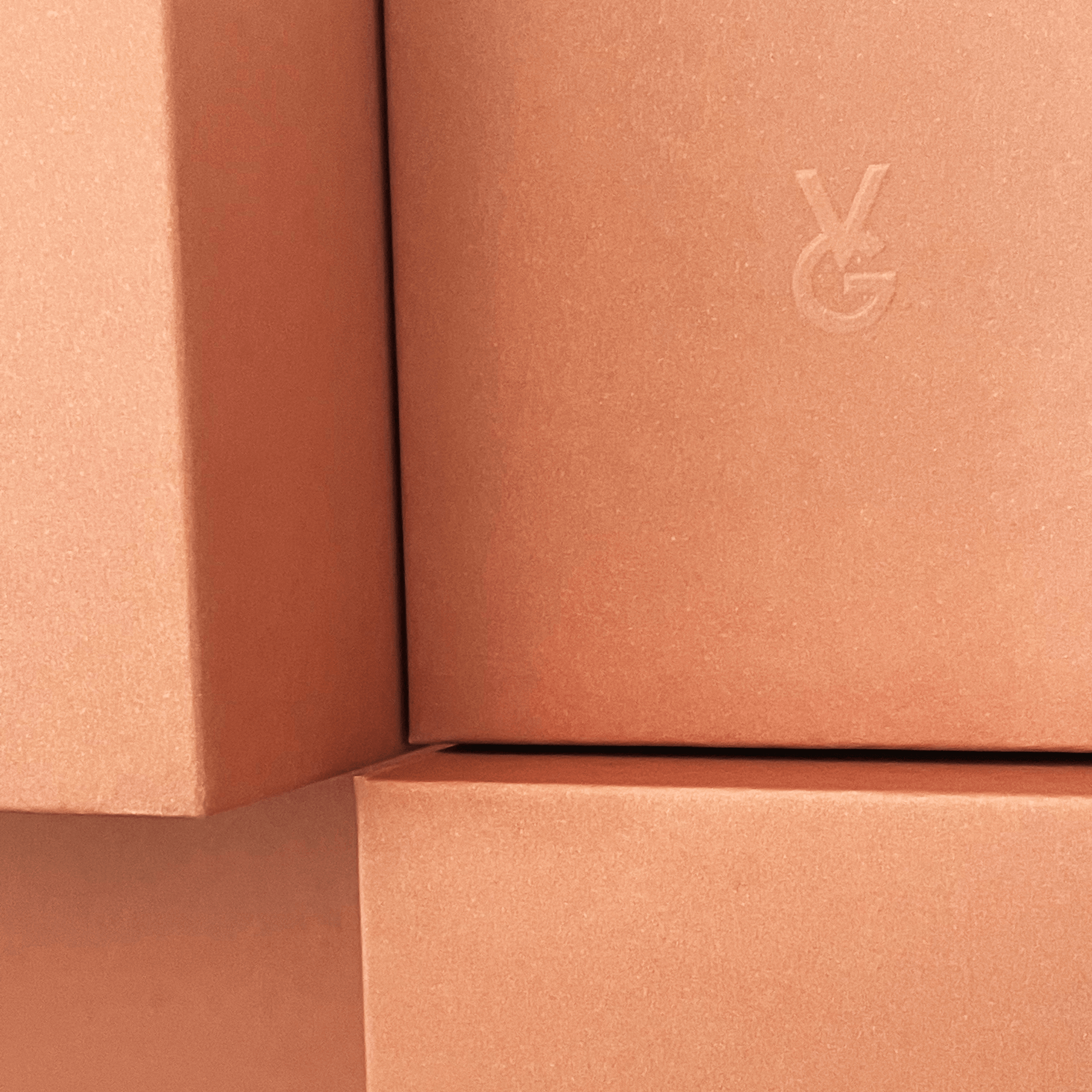 Close-up of a orange box with a Vida Glow logo on a matching background