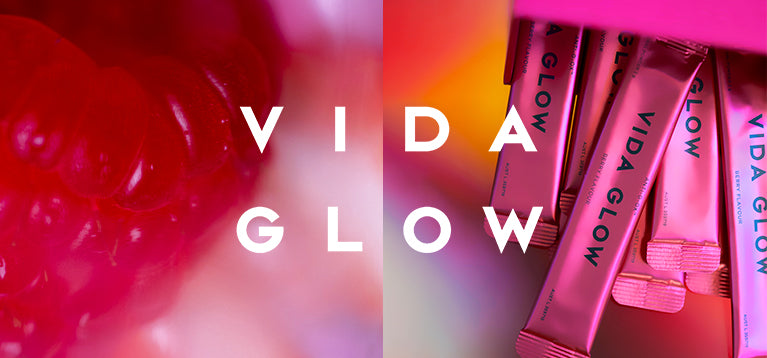 Vida Glow berry flavour products with a close-up of a raspberry on a pink background