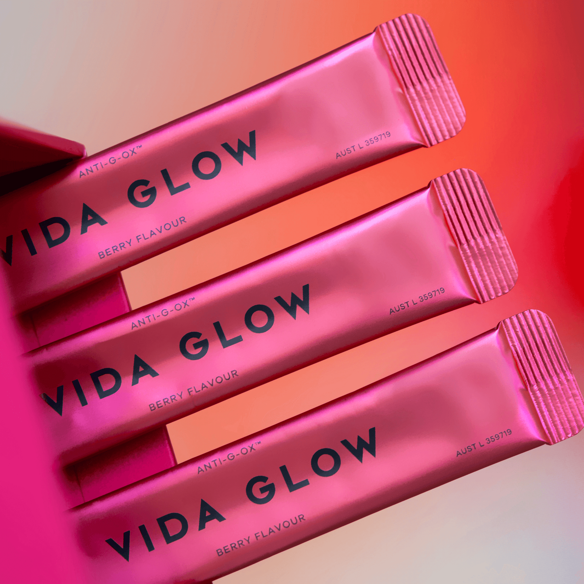 Vida Glow anti-g-ox berry sachets on pink and orange background