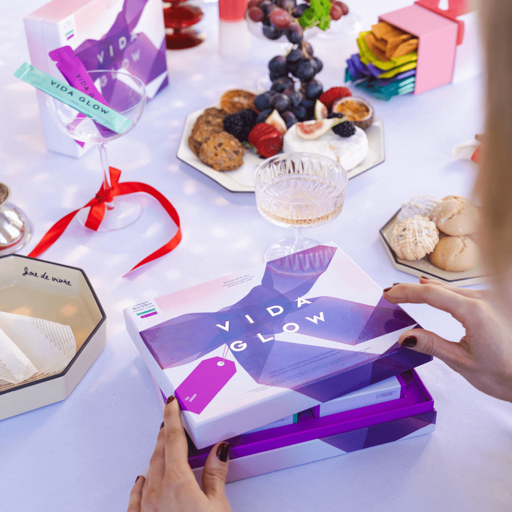 Vida Glow collagen limited edition packs on festive table with food and drinks