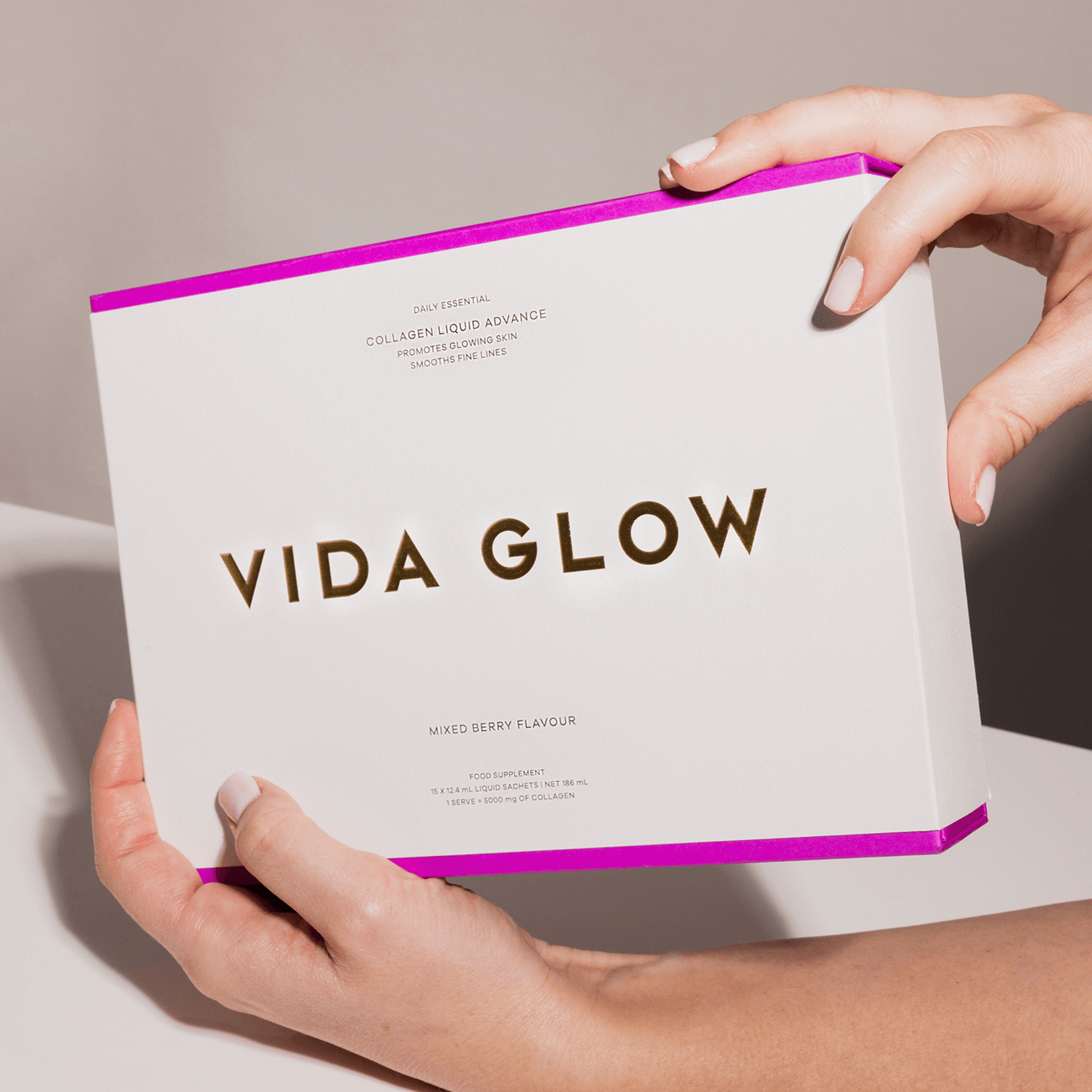 Vida Glow liquid advance product box held in hands