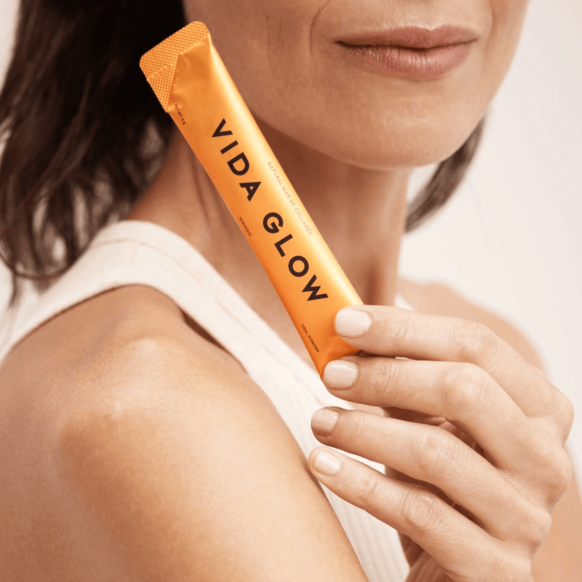 Vida Glow Mango flavour sachet being held