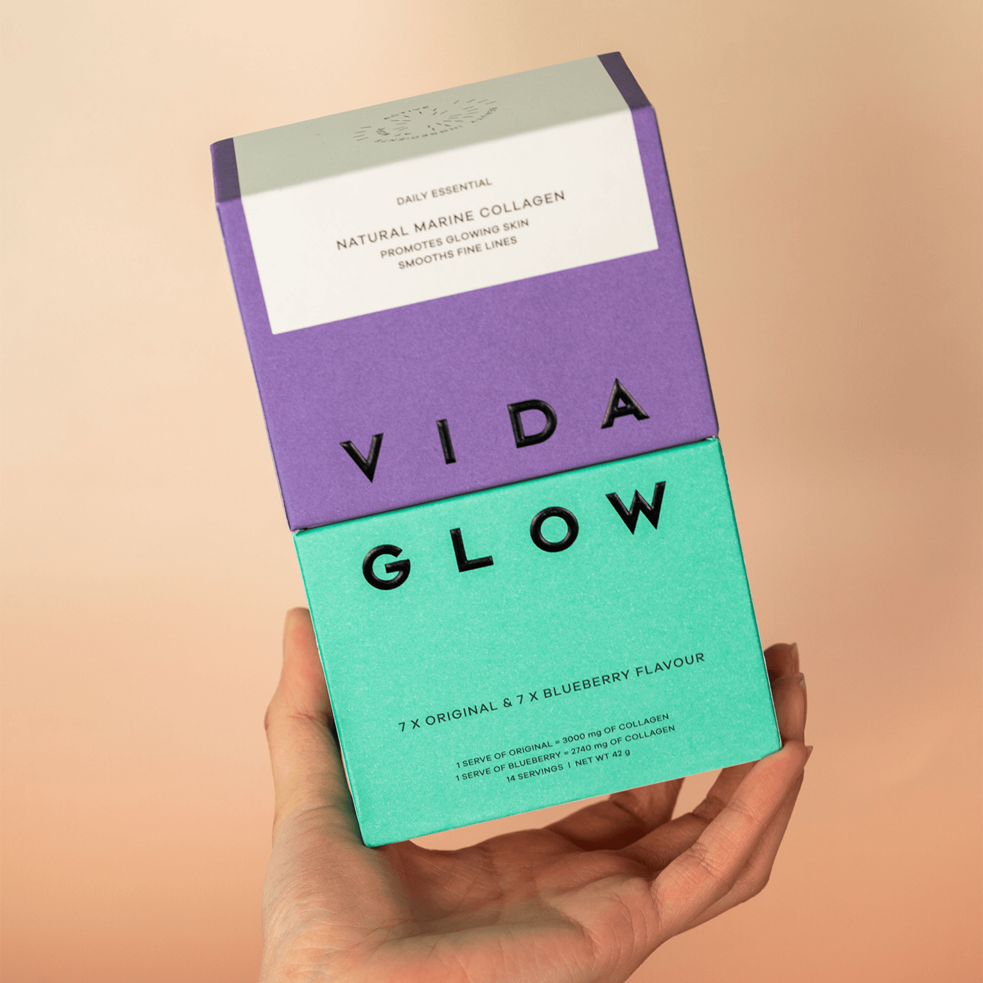 Vida Glow original blueberry trial mixed pack in had of model on peach background