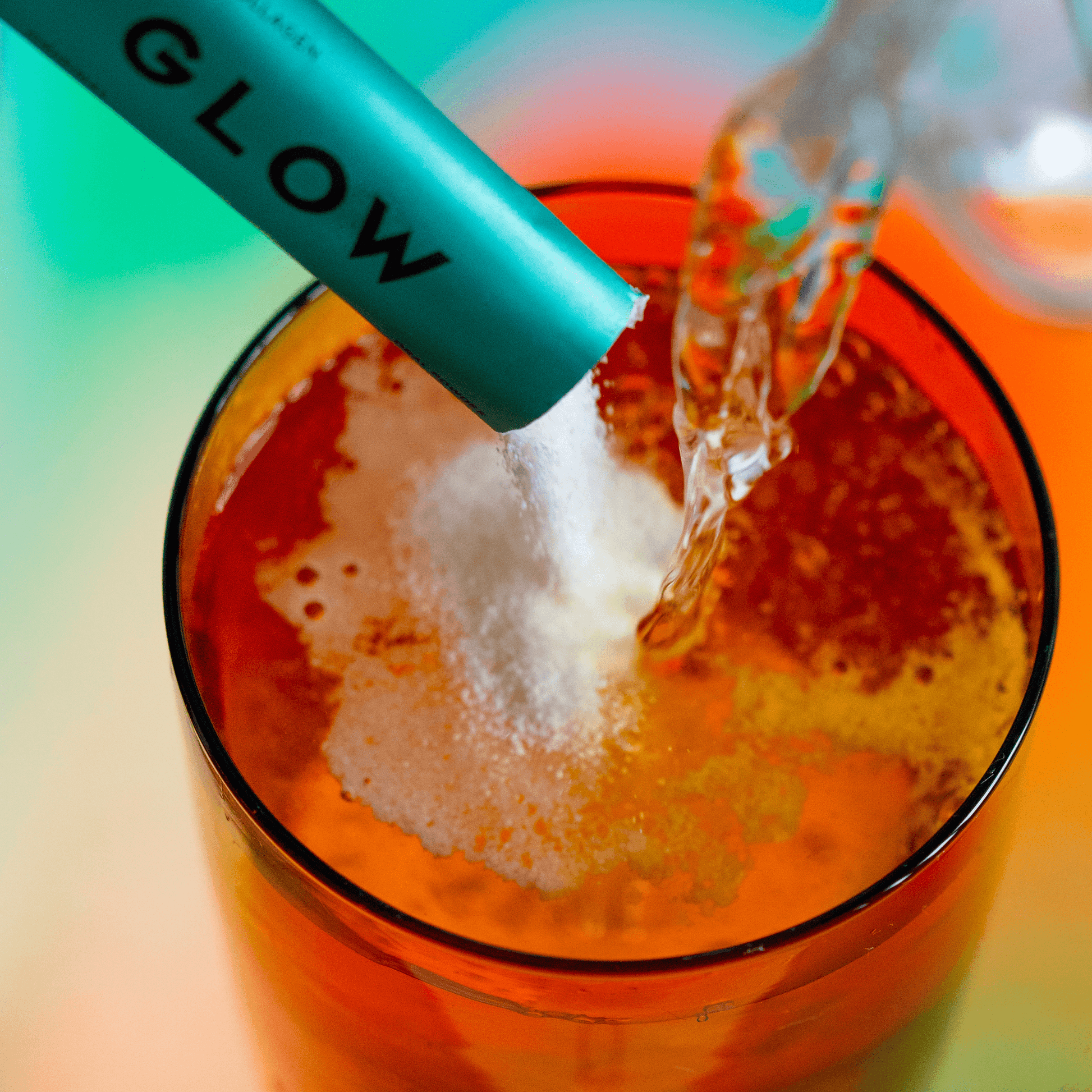 Vida Glow original flavour sachet poured into orange glass of water