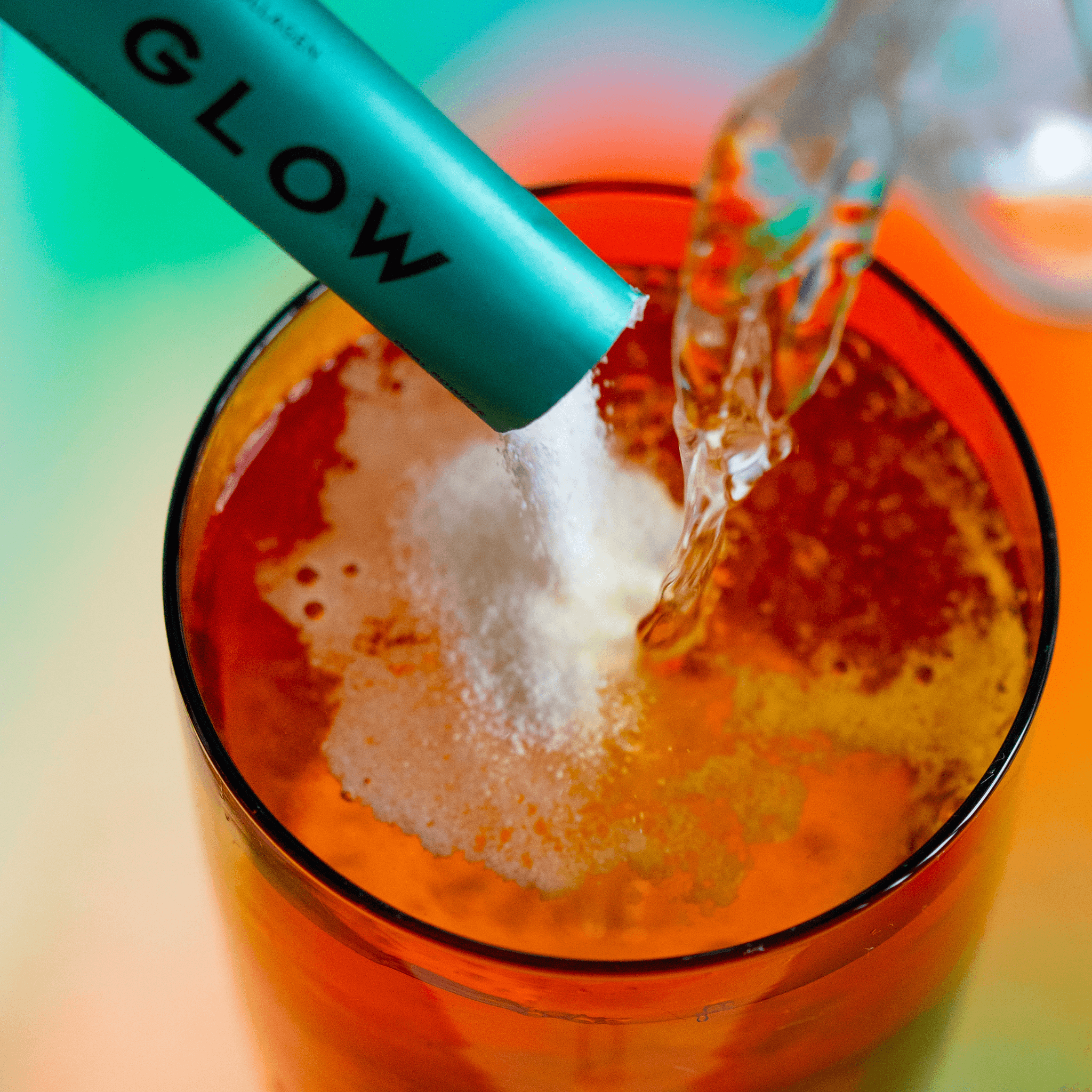 Vida Glow original flavour sachet poured into orange glass of water