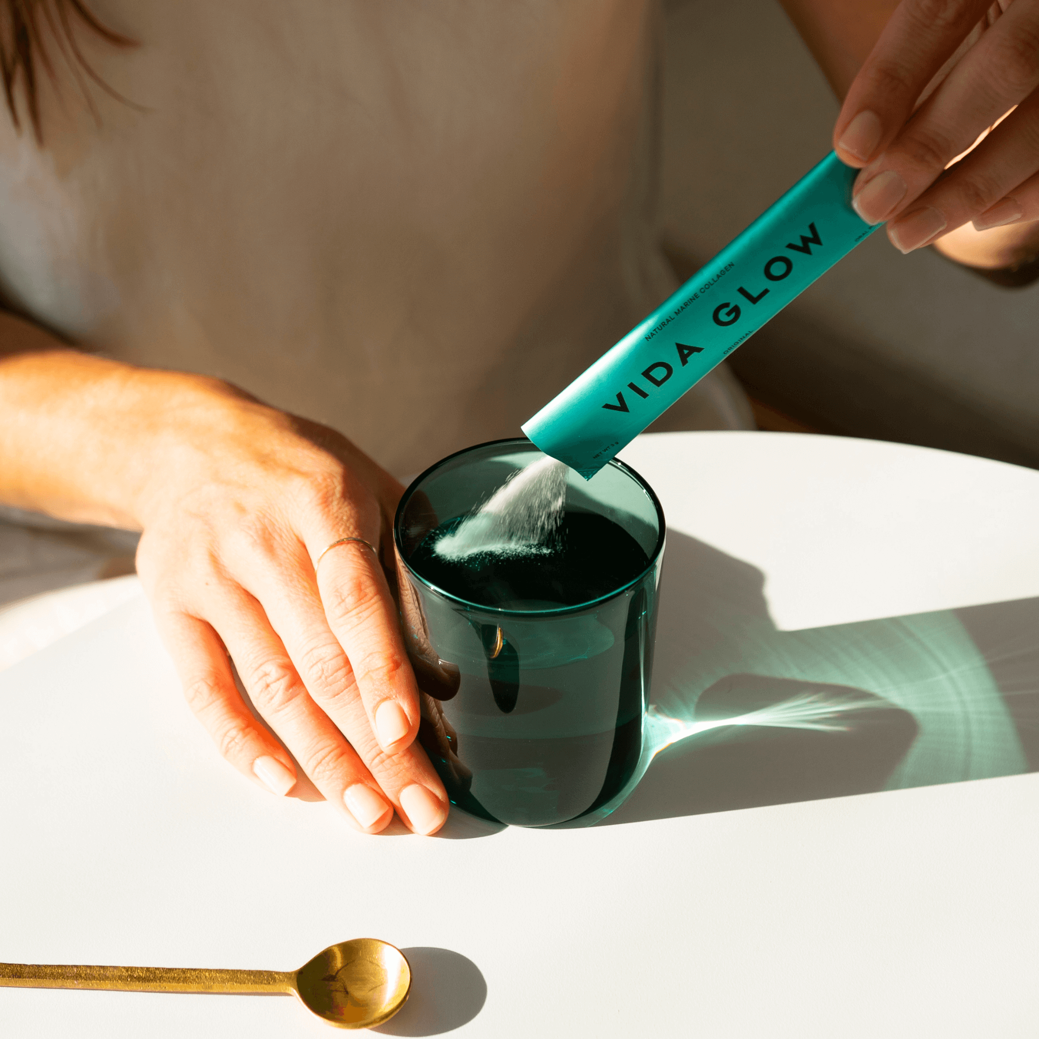 Vida Glow original sachet powder poured into water