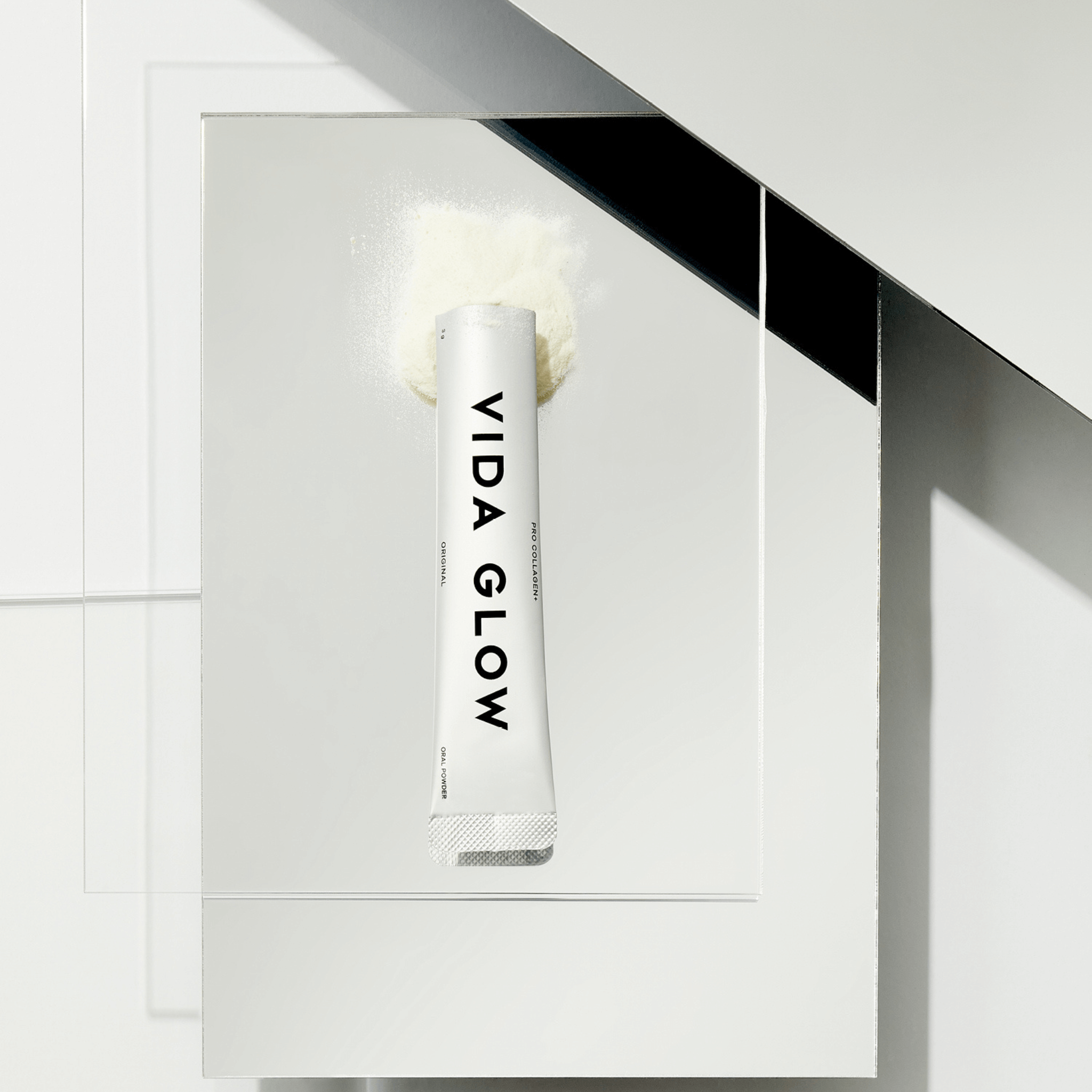 Vida Glow pro collagen sachet and powder on silver background