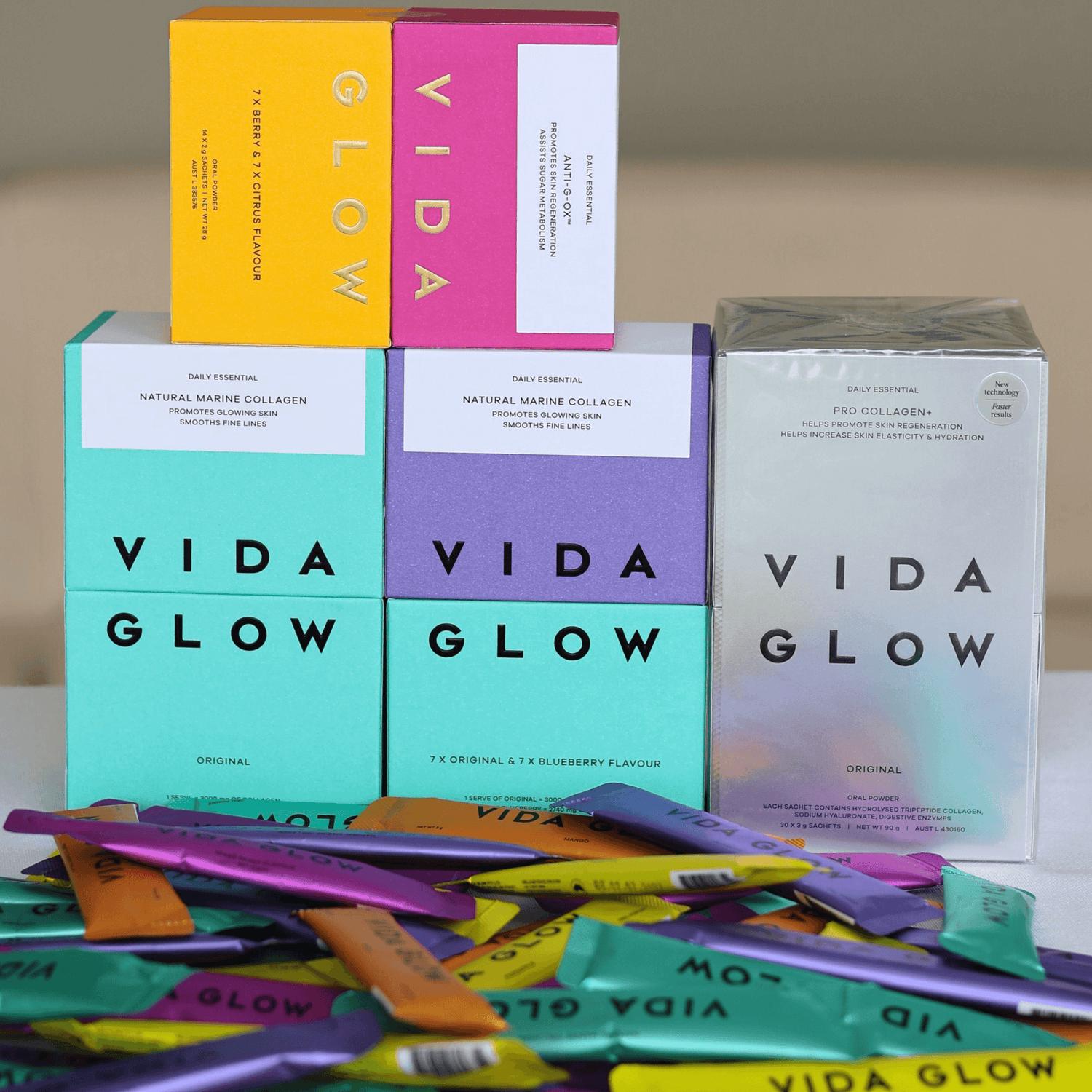 Vida Glow product packaging including boxes and packets on a neutral background